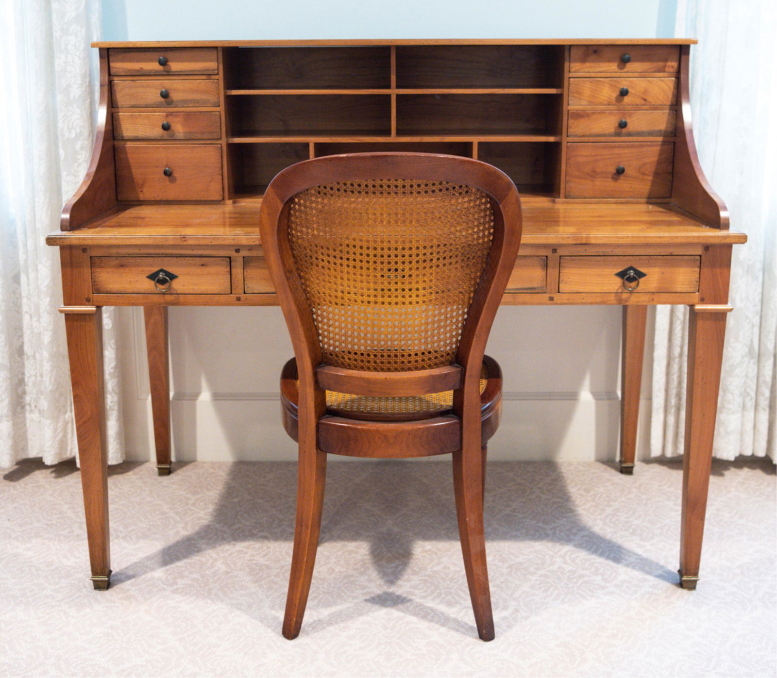 CONTEMPORARY GEKA DESK & CANED CHAIR: Well-made contemporary desk with brass foot caps and desk chair with caned back and seat. Stamped Geka to drawer side in desk. Chair unmarked. Dimensions: (Desk) H 45" x W 53" x D 27.5" Condition: Sur