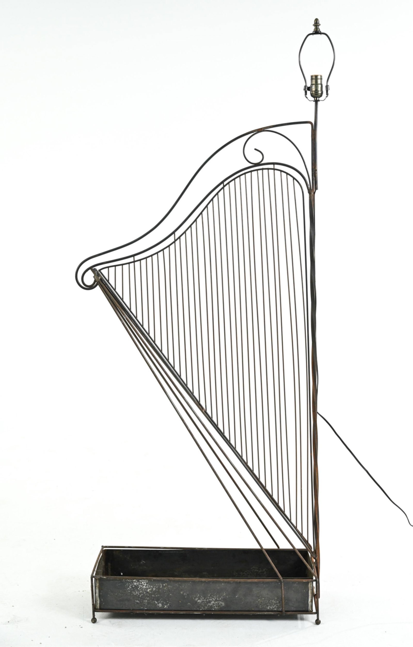 ARTISAN WROUGHT IRON HARP PLANTER, AS FLOOR LAMP: One-of-a-kind harp-form planter in wrought iron and mixed metal, mounted as a floor lamp. Apparently unsigned. Dimensions: H (to finial) 65" x W 25" x D 9.5" Condition: Wiring not tested. Showing norm