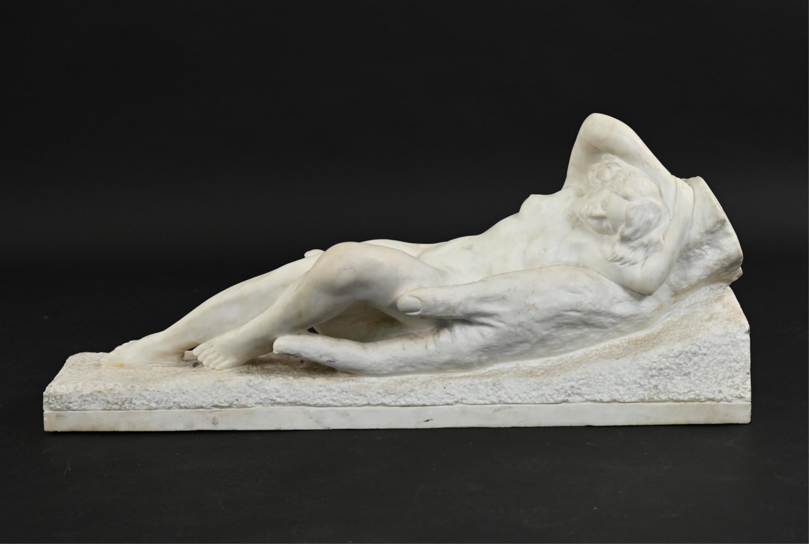 ANTIQUE CARVED MARBLE RECLINING NUDE SCULPTURE: Antique figurative sculpture of a nude woman reclining inside a large hand; apparently unsigned. Dimensions: H 16" x W 14" x L 39.5" Condition: Showing some wear, including a few small cracks, chips, 