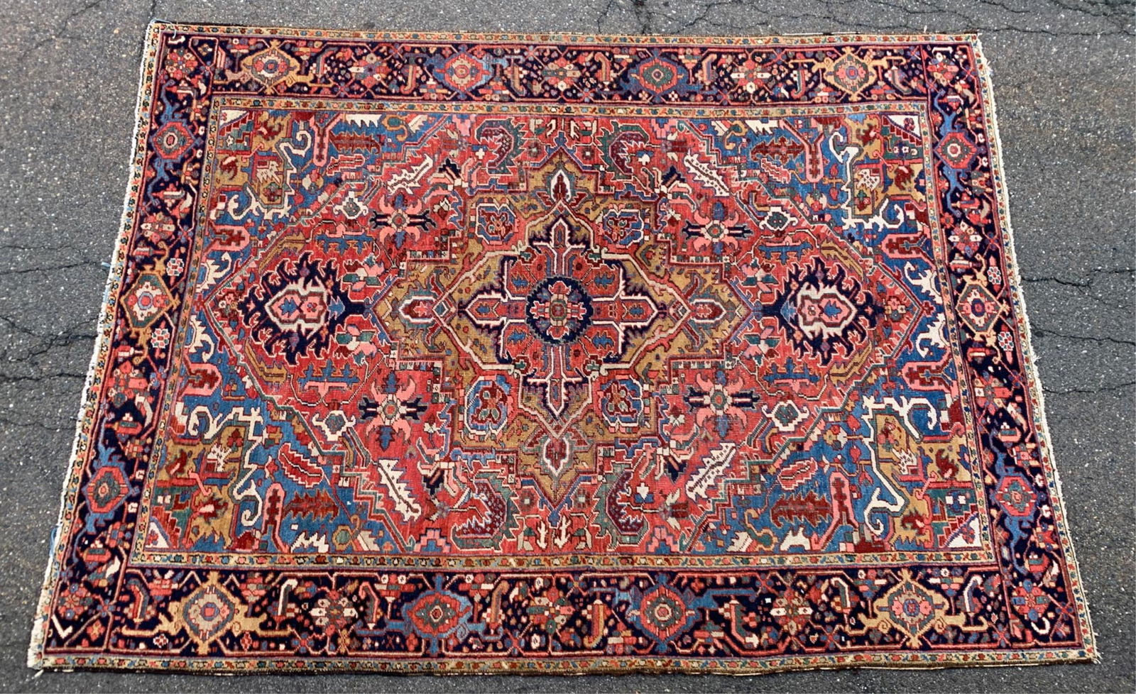 SEMI-ANTIQUE PERSIAN HERIZ RUG: Dimensions: L 124" x W 88" Condition: Signs of use including wear to some edges, fringe trimmed down, some thin areas.