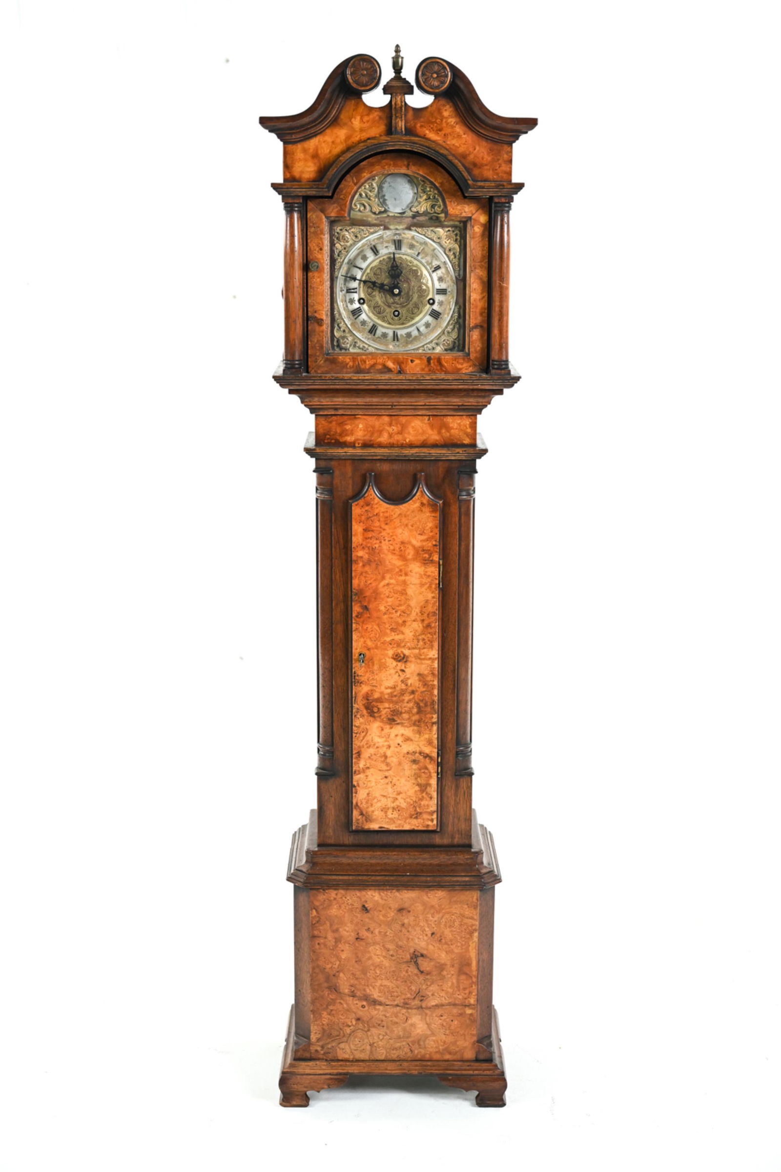 JOHN THOMPSON LONDON CLOCK: Tall case clock in diminutive proportions. Marked John Thompson, London above face. With burlwood case, ornately engraved face. Dimensions: H 58" x W 13" x D 8.75" Condition: Not tested. Wear and tarn