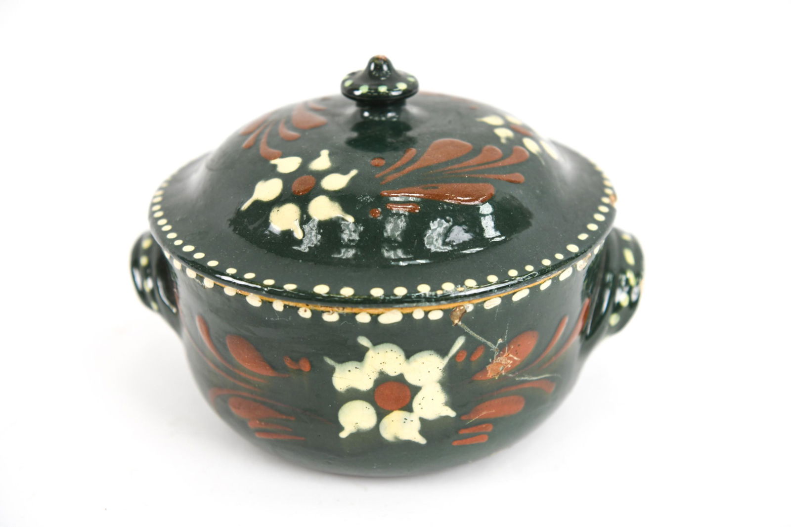 ANTIQUE FRENCH EARTHENWARE TERRINE: Antique pottery terrine in deep green glaze with slip-trailed floral motifs. Turn-of-the-century. Used for foie gras. Dimensions: (With lid) H 6" x Dia. 8.5" Condition: Wear consistent with antique ag