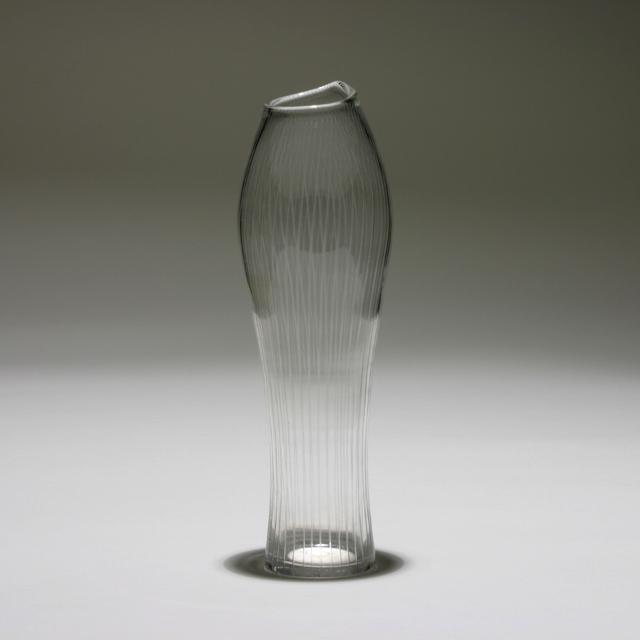 TAPIO WIRKKALA FOR IITTALA GLASS VASE: Vase. Made by Iittala, Helsinki. Finland, 1956. Glass. Engraved on the underside: "TAPIO WIRKKALA IITTALA -56." Dimensions: H 10" x Dia. 3" Condition: Flea bite and light surface scratches underneath.