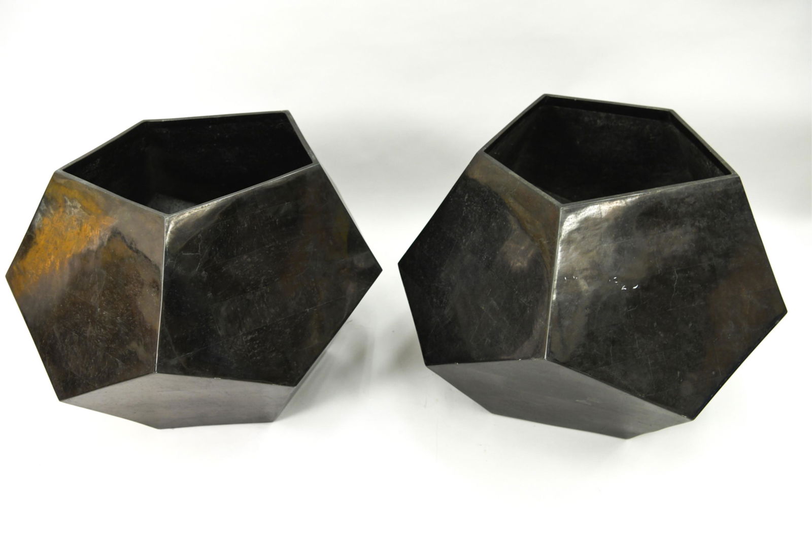 PAIR MARQUIS COLLECTION STONE POLYHEDRON PLANTERS: Modern black polyhedron tessellated fossil stone veneer planters. Marquis Collection of Beverly Hills. Label under. Dimensions: H 23" x W 30" x D 30" Condition: Surface wear, marked and scratches cons