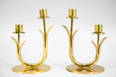 PAIR OF GUNNAR ANDER FOR YSTAD CANDLESTICKS: Pair of Swedish mid-century brass flower-form candlesticks. Designed by Gunnar Ander for Ystad-Metall, c. 1960's. Marked underneath. Dimensions: H 4.75" x W 3.25" x D 3" Condition: Tarnish, some verdi