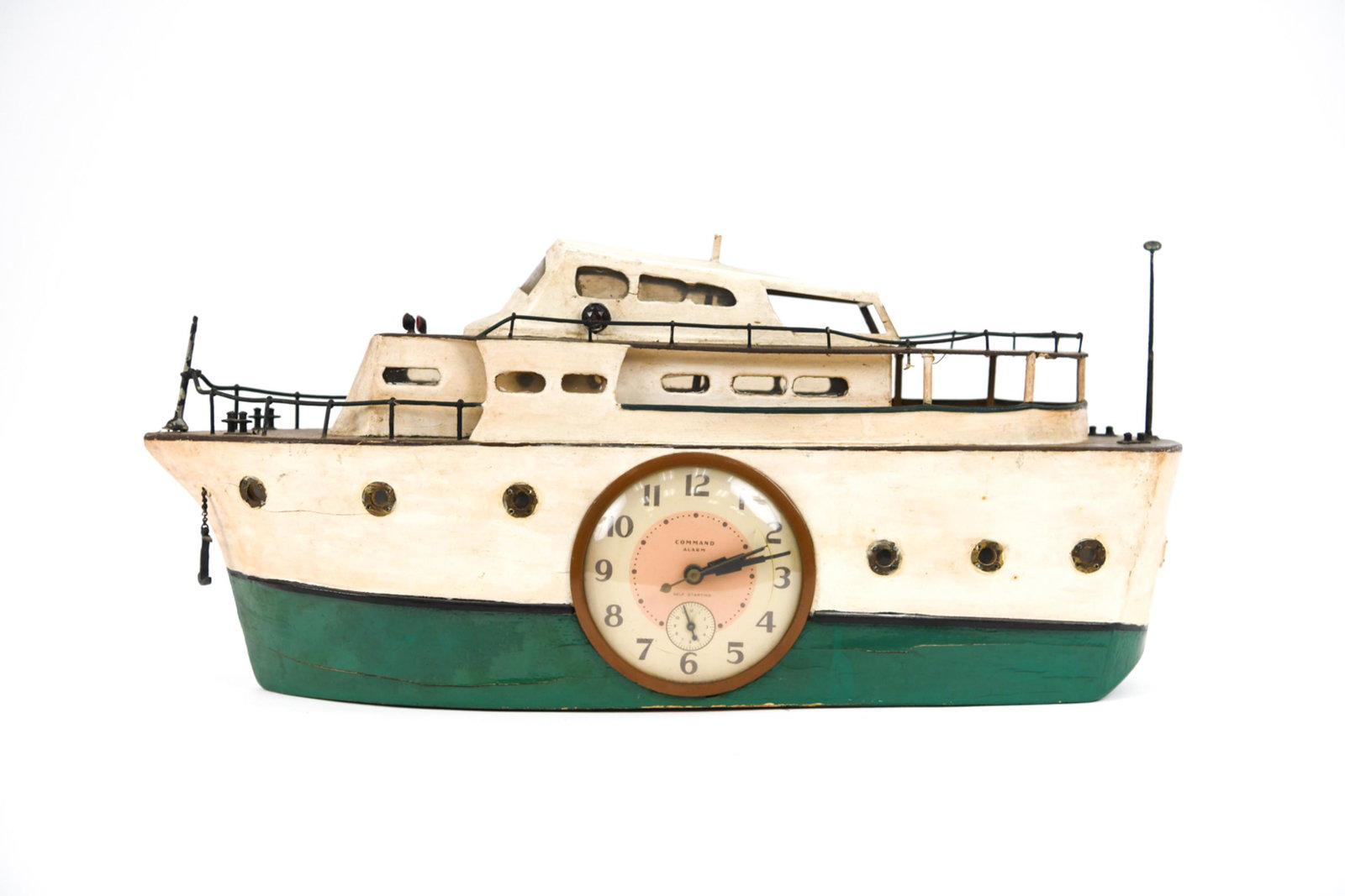 FOLK ART WOODEN BOAT CLOCK: Wooden folk art boat with inlaid clock and internal light. Dimensions: H 9.5" x W 21" x D 6" Condition: Handmade hollow wooden boat that lights up with a bulb from the inside and holds a clock. Access
