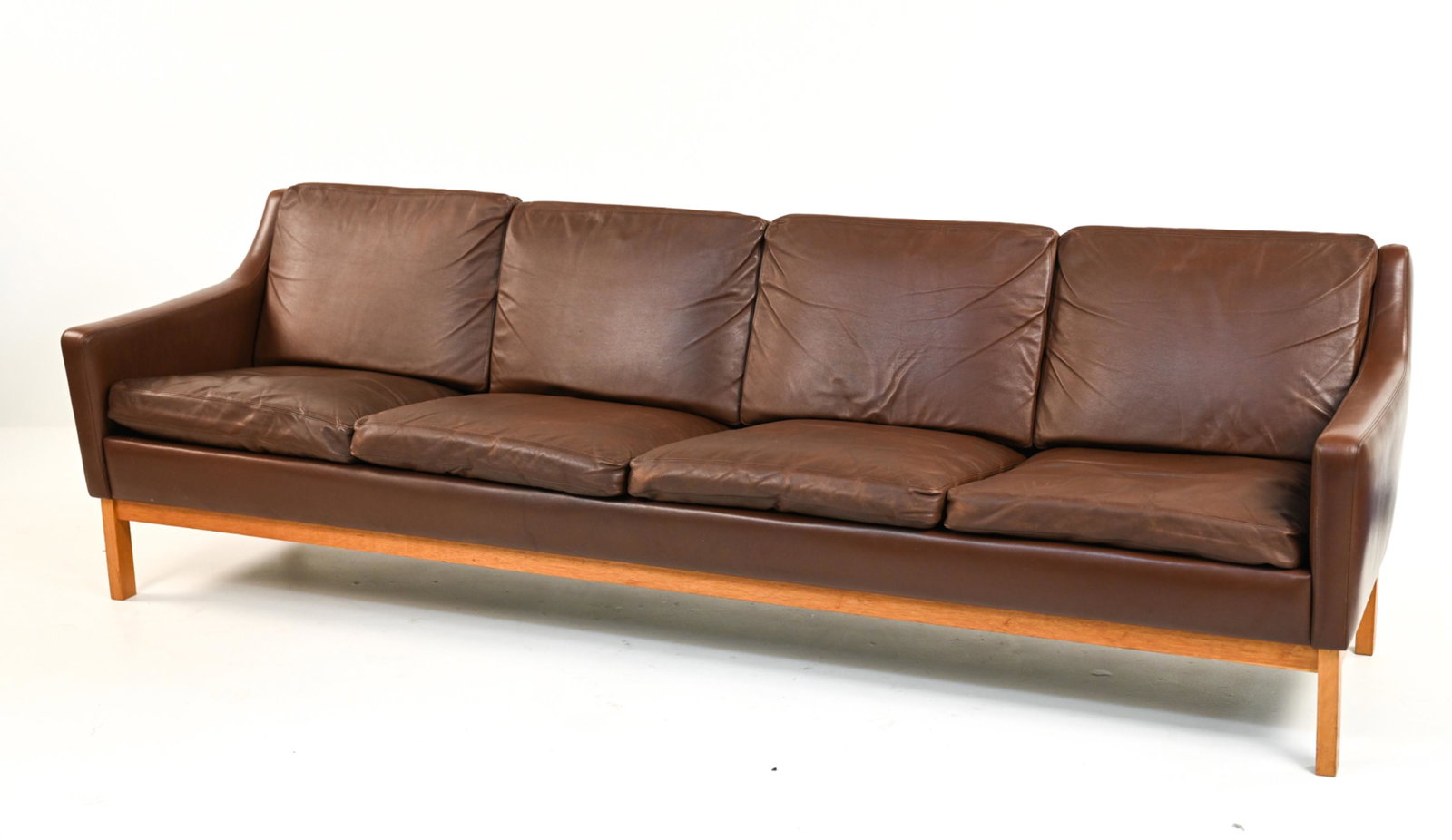 MID-CENTURY DANISH 4 SEAT ERIK WORTS SOFA: Unique 4 seat mid-century Danish sofa by Erik Worts. Dimensions: H29" x W 95" x D 29"x SH 17" Condition: Sofa shows wear consistent with its age. The leather seating area shows creasing from usage. Li