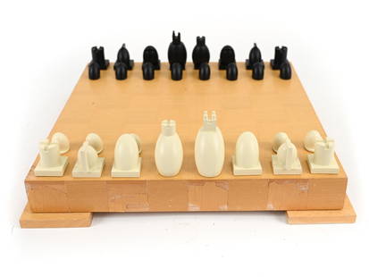 MICHAEL GRAVES POST-MODERN BRAUN CHESS SET: All pieces marked underneath. Dimensions: (Box) H 2.75" x W 18" x D 18" Condition: Losses to veneer on box. Inside pieces with light use wear.