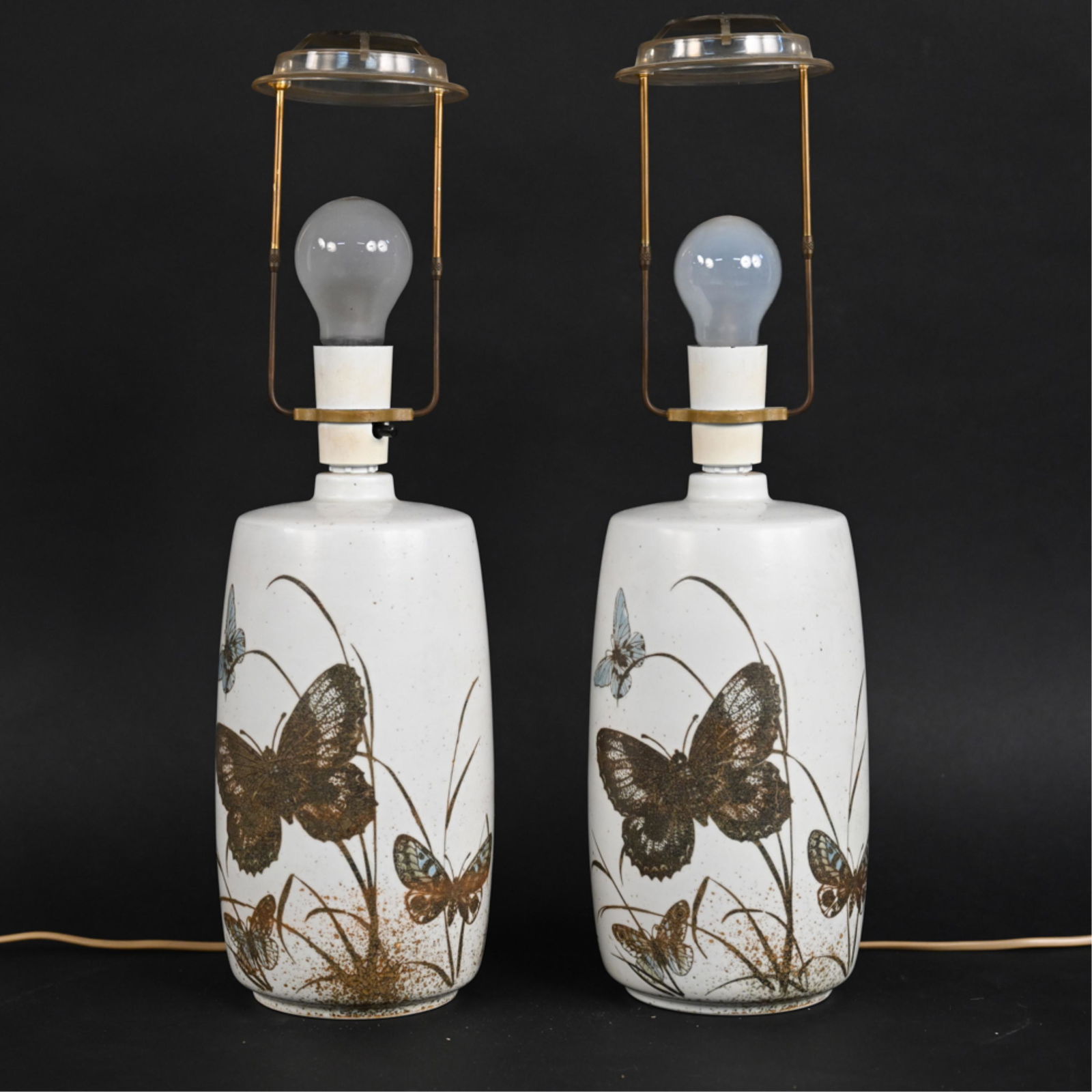 PAIR OF NILS THORSSON CERAMIC BUTTERFLY LAMPS: Pair of Mid Century Danish lamps with a butterfly motif. Manufactured by Royal Copenhagen Dimensions: H 19" x Dia 5.5" Condition: Ceramic shows mild soiling. No chipping present. colors are bright. La