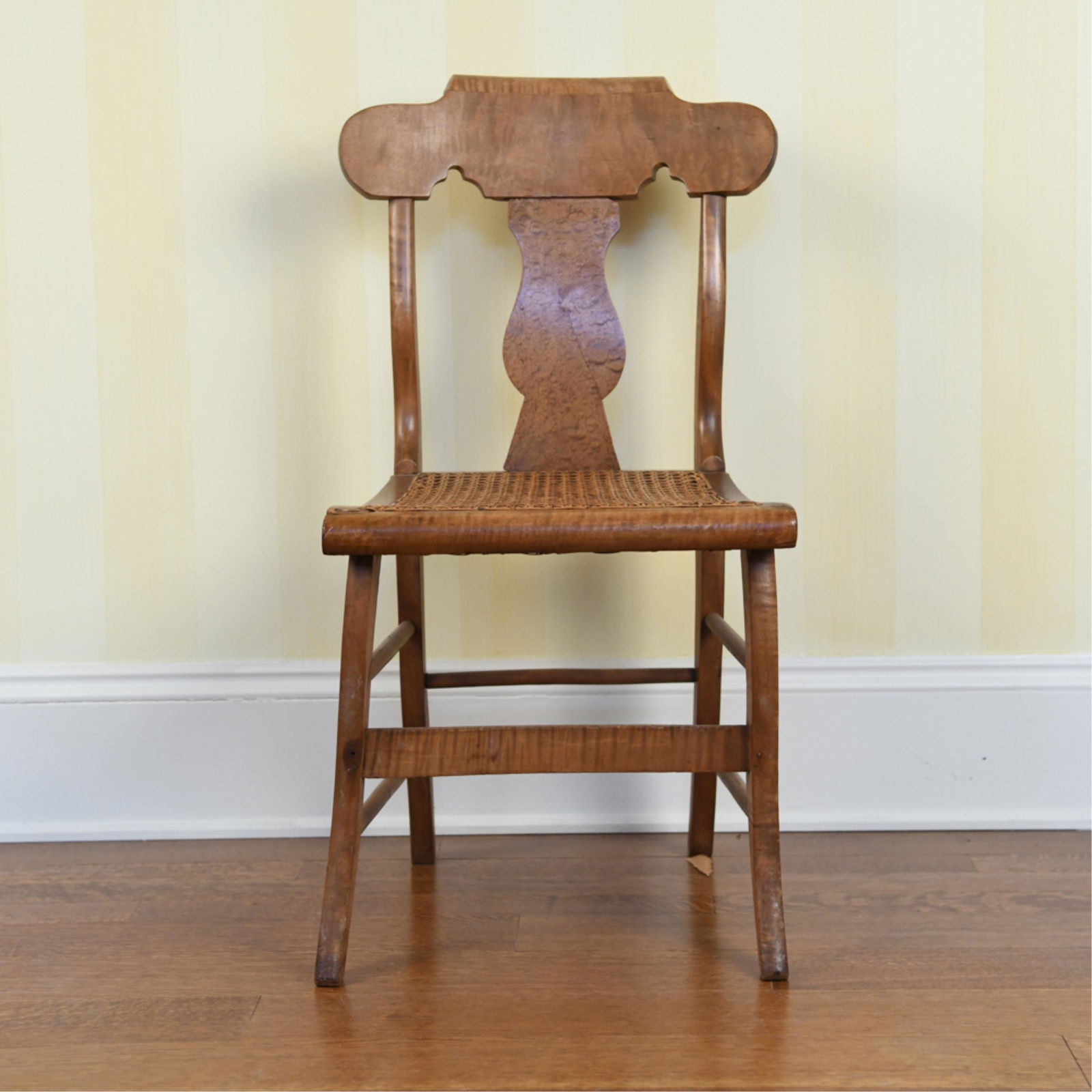 MAPLE SIDE CHAIR: With caned seat. Dimensions: H 34.25" x W 18.5" x D 18" x SH 17.5" Condition: Previous repairs. Splits to wood. Slightly wobbly.