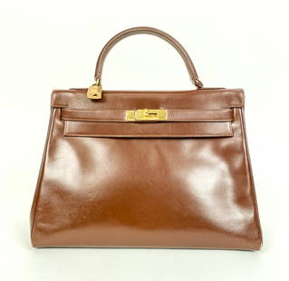 1989 HERMES KELLY RETOURNE 32 BOX CALF GOLD PLATED: Genuine vintage Hermes Kelly Retourne bag, size 32, in Box Calf leather with gold-plated hardware. Leather is a deep red color - likely Rouge Hermes. Blind stamp indicates production year 1989. Should