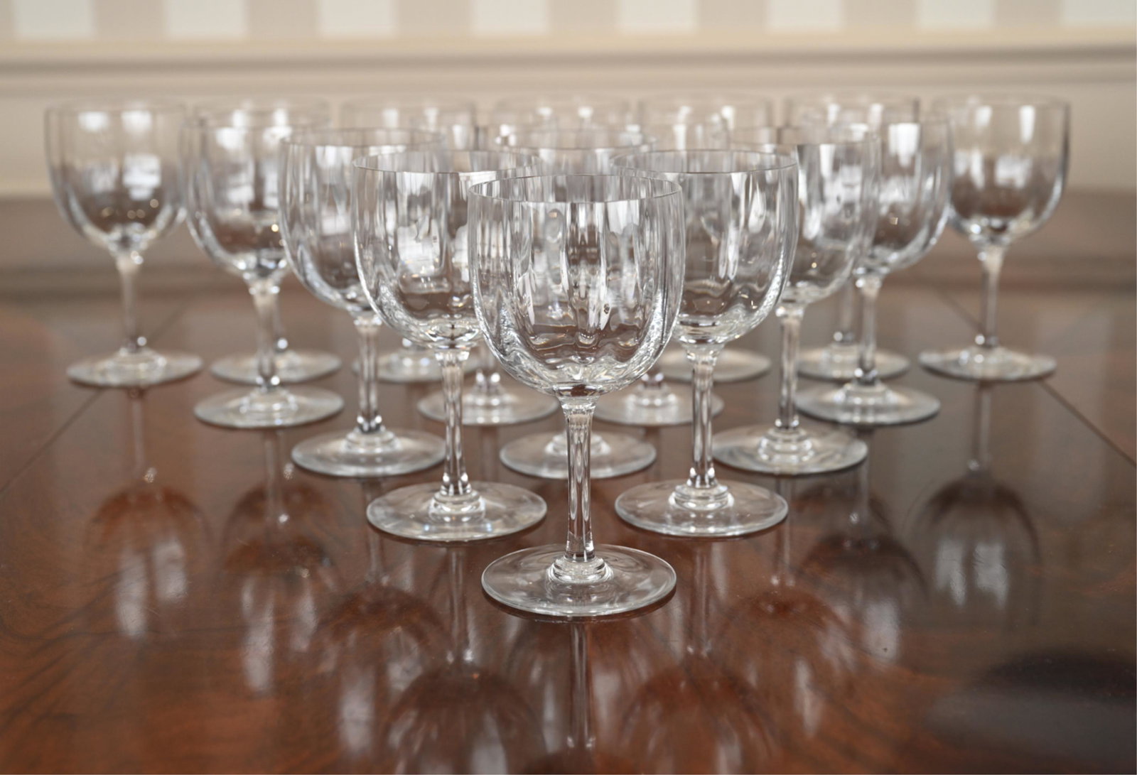 (17) BACCARAT CRYSTAL WINE GLASSES: With optical bowl, etched marking underneath. Dimensions: H 7" x Dia. 3.5" Condition: Light wear consistent with age and use.