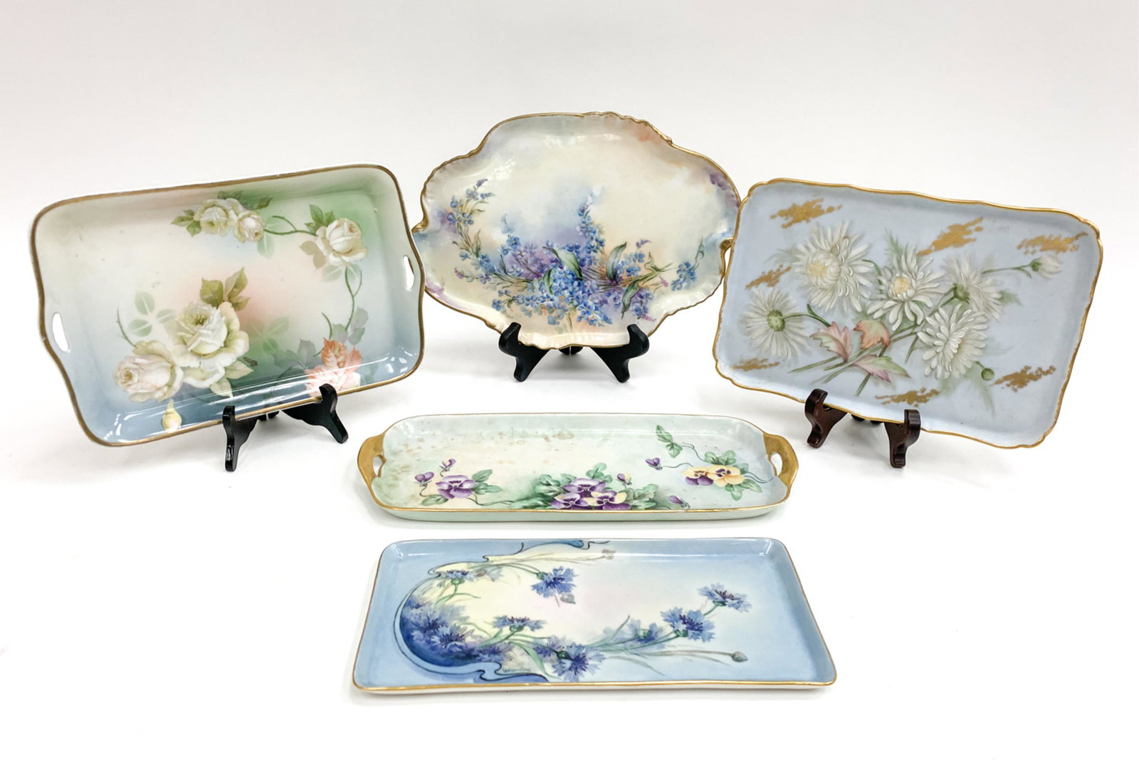 (5) ANTIQUE DECORATED PORCELAIN TRAYS: Variously marked. Including Limoges. Dimensions: (Longest) L 14.25" x W 5" Condition: Rubbing to the gold. Few marks of rubbing to decoration.