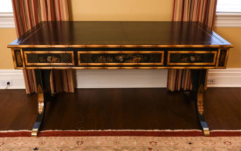 CHINOISERIE-STYLE DESK: Labeled inside drawer: Julia Gray Ltd., New York. In the manner of Maitland Smith. Chinoiserie-style leather top desk with hand-painted drawers and faux bamboo accents. Brass castors included.