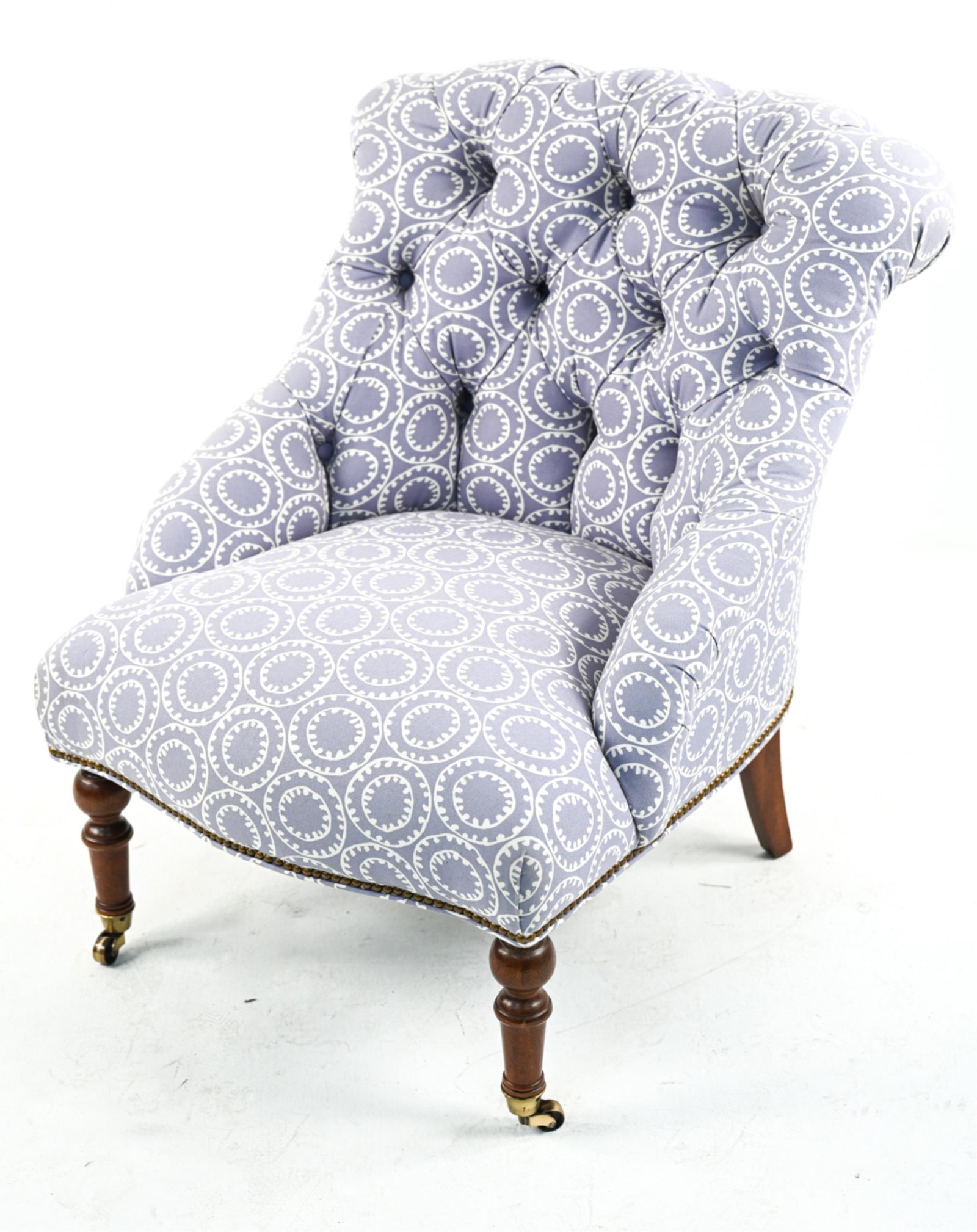 ATTR. PEARSON FURNITURE TUFTED SLIPPER CHAIR: With periwinkle medallion-print linen upholstery; on turned front legs with brass casters. Dimensions: H 36" x W 28" x D 30" x SH 17" Condition: Chair sturdy. A few small spots of soiling to front cor