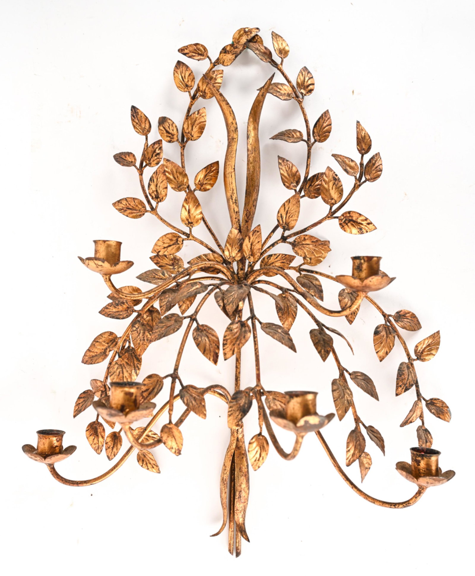 GILT METAL CANDLE SCONCE: Dimensions: H 24" x W 18.5" x D 8" Condition: Showing normal light wear consistent with age; a few minor bends, rubbing and some losses to gilding, patina to exposed metal, some wax remnants.