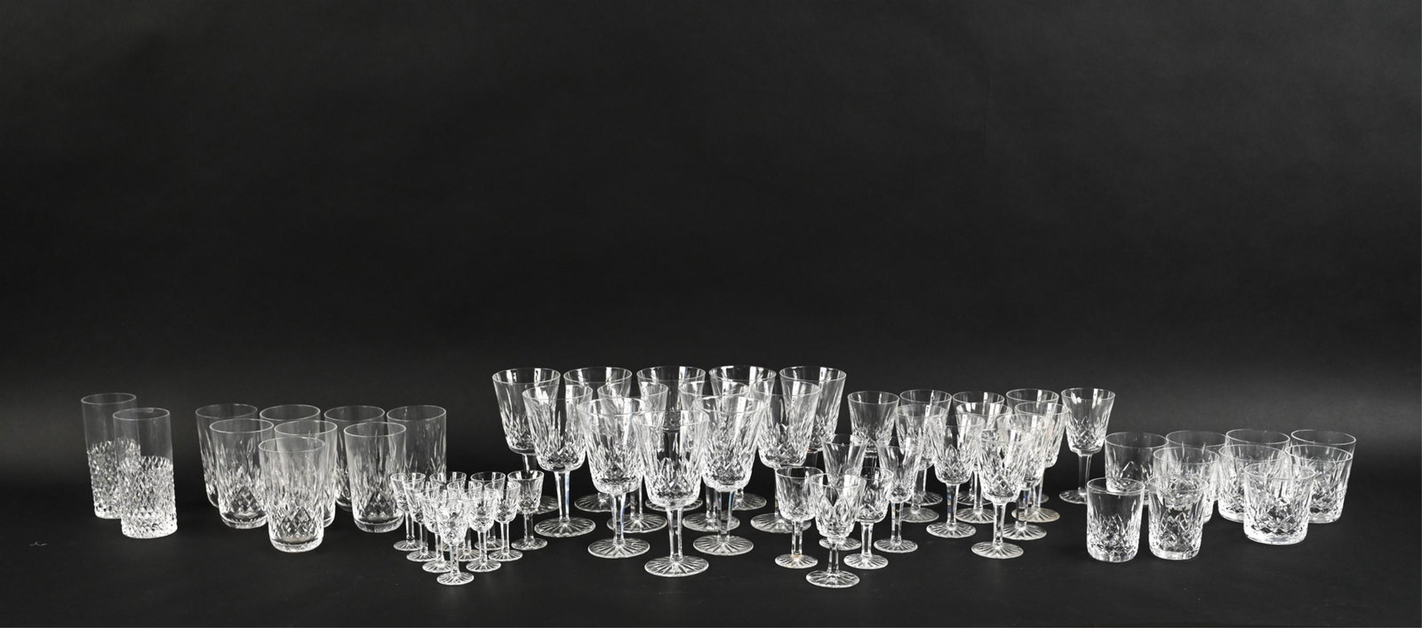 GROUPING OF WATERFORD CRYSTAL GLASSWARE: Grouping of Waterford cut crystal stemware and barware, including: (12) water goblets, (11) small white wine goblets, (10) cordials, (2) sherry goblets, (2) port goblets, (8) double old fashioned glas