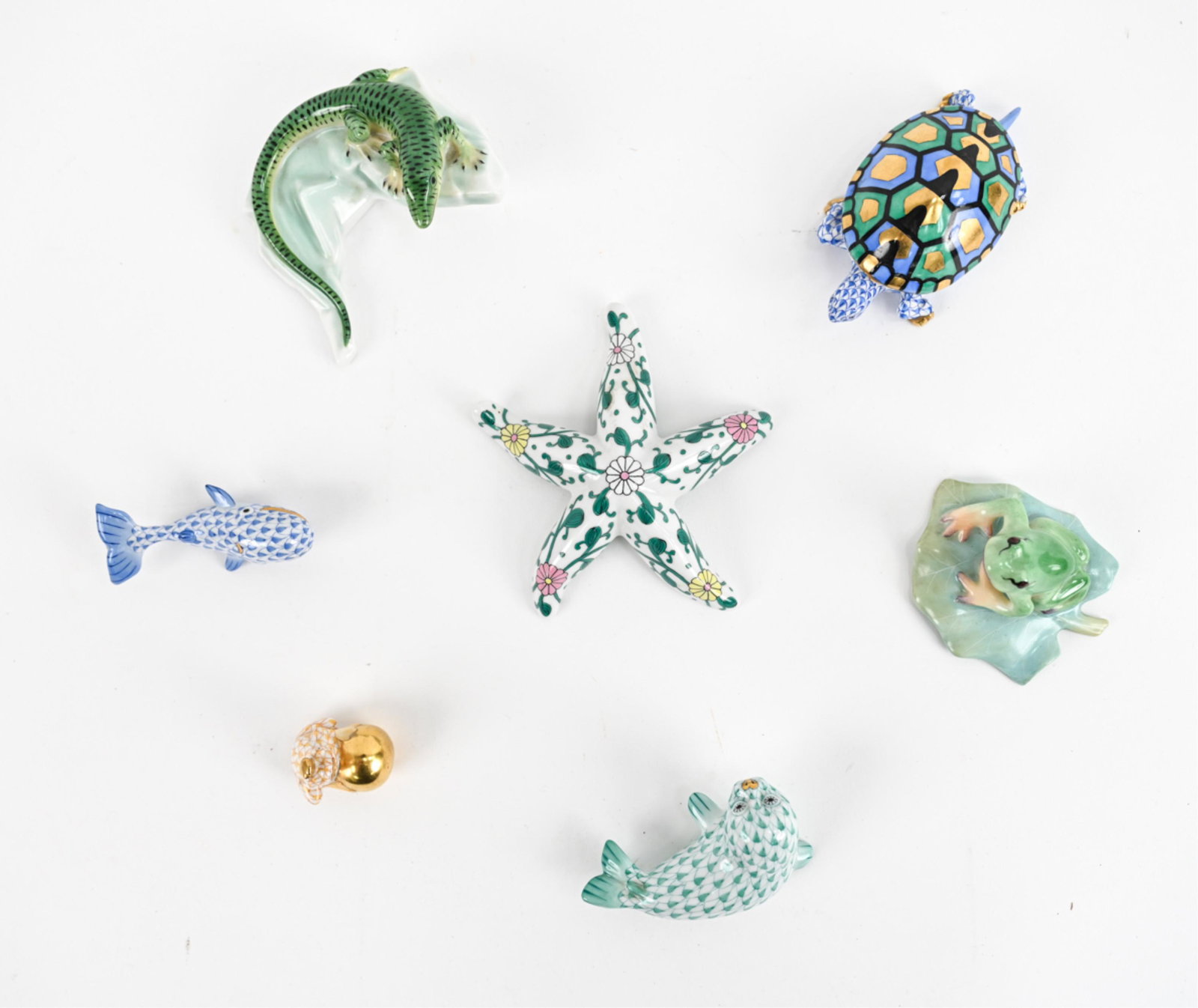 GROUPING OF HEREND PORCELAIN ANIMAL FIGURINES: (7) Delightful Herend figurines. Alligator, whale, starfish, seal, turtle and (2) frogs. Hand painted and accented with 24K gold. Signed and numbered. Made in Hungary. Dimensions: (Starfish) H 1.25" x