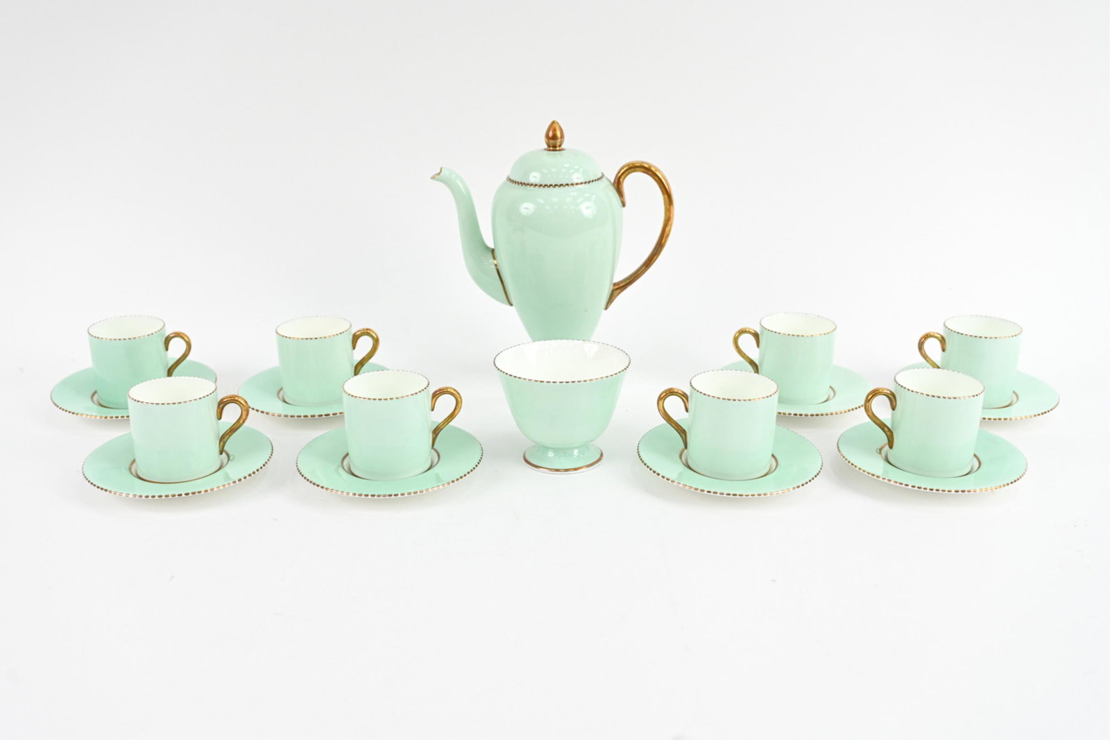 WEDGWOOD PORCELAIN DEMI-TASSE SERVICE: Wedgwood porcelain demi-tasse service for (8) in mint green with gold rims. Marked underneath. Including sugar bowl, coffee pot, (8) cups, and (8) saucers. Dimensions: (Coffee pot) H 8.5" x W 7.25" x 