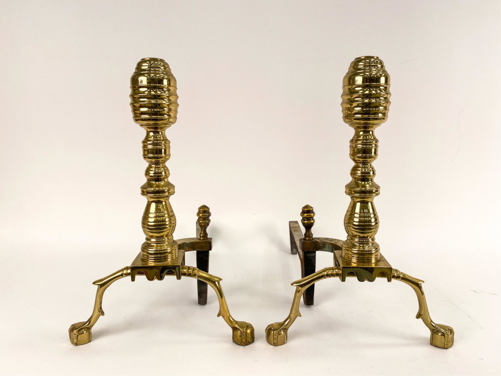 PAIR OF VINTAGE EMPIRE-STYLE ANDIRIONS: Brass and iron. Both marked underneath. Dimensions: H 19.5" x W 12" x D 23" Condition: Used, with some surface degradation.