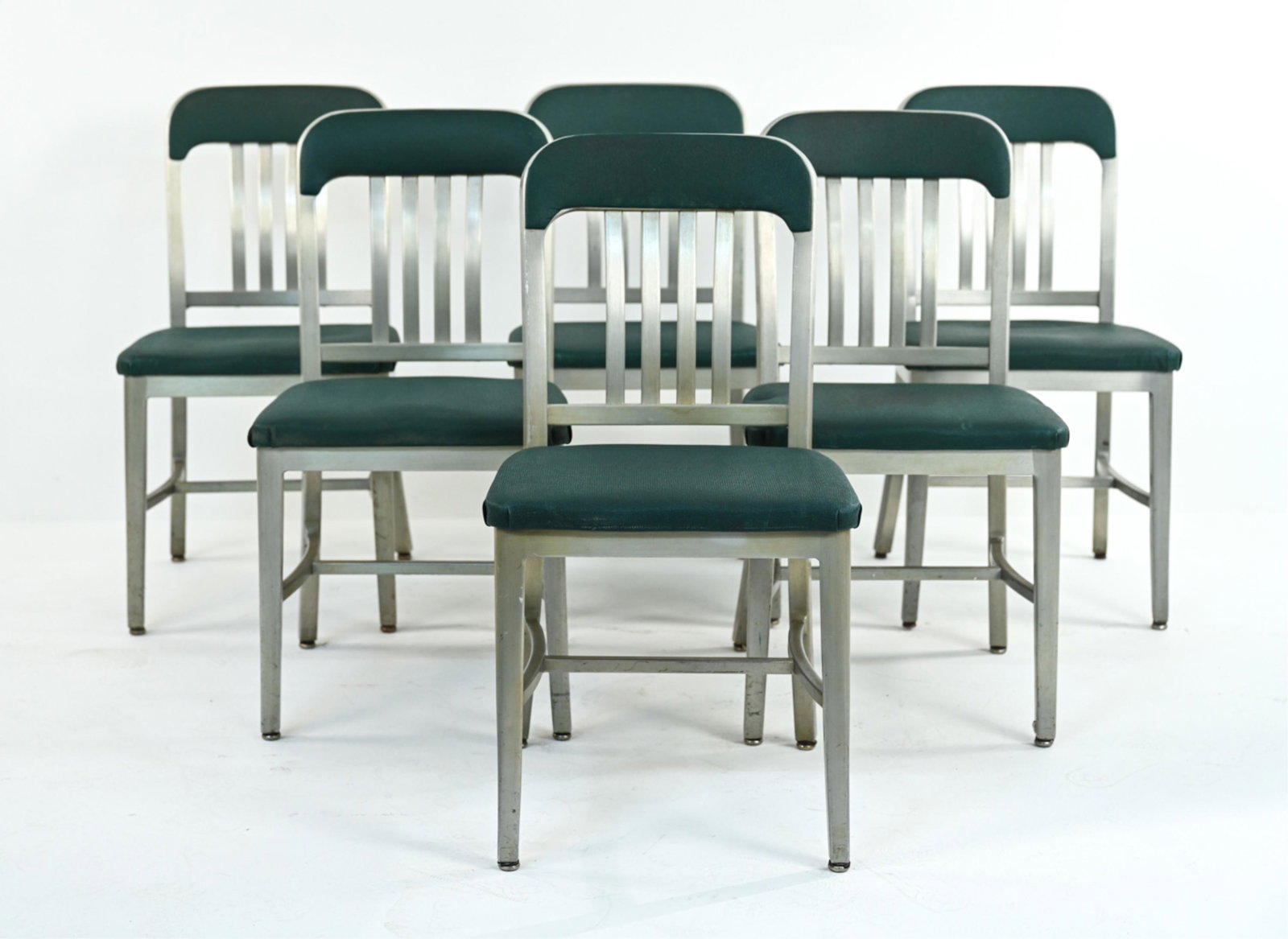 (6) 1940'S GOODFORM ALUMINUM NAVY-STYLE CHAIRS: Fantastic set of (6) 1940's aluminum side chairs by Goodform, in the style of Emeco's Navy chair. Brushed finish, with original textured vinyl upholstery. Several chairs with original metal and/or pap