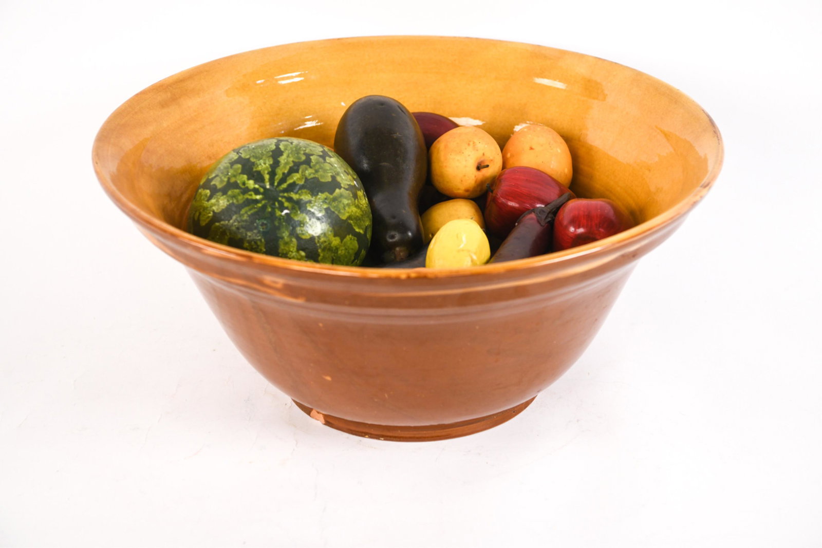 OVERSIZED EARTHENWARE BOWL W/ FAUX FRUIT: French Provincial-style yellow earthenware bowl, marked Pottery Barn underneath; with an assortment of painted foam and papier-mache faux fruit. Dimensions: (Bowl) H 9.5" x Dia. 21.25" Condition: For 