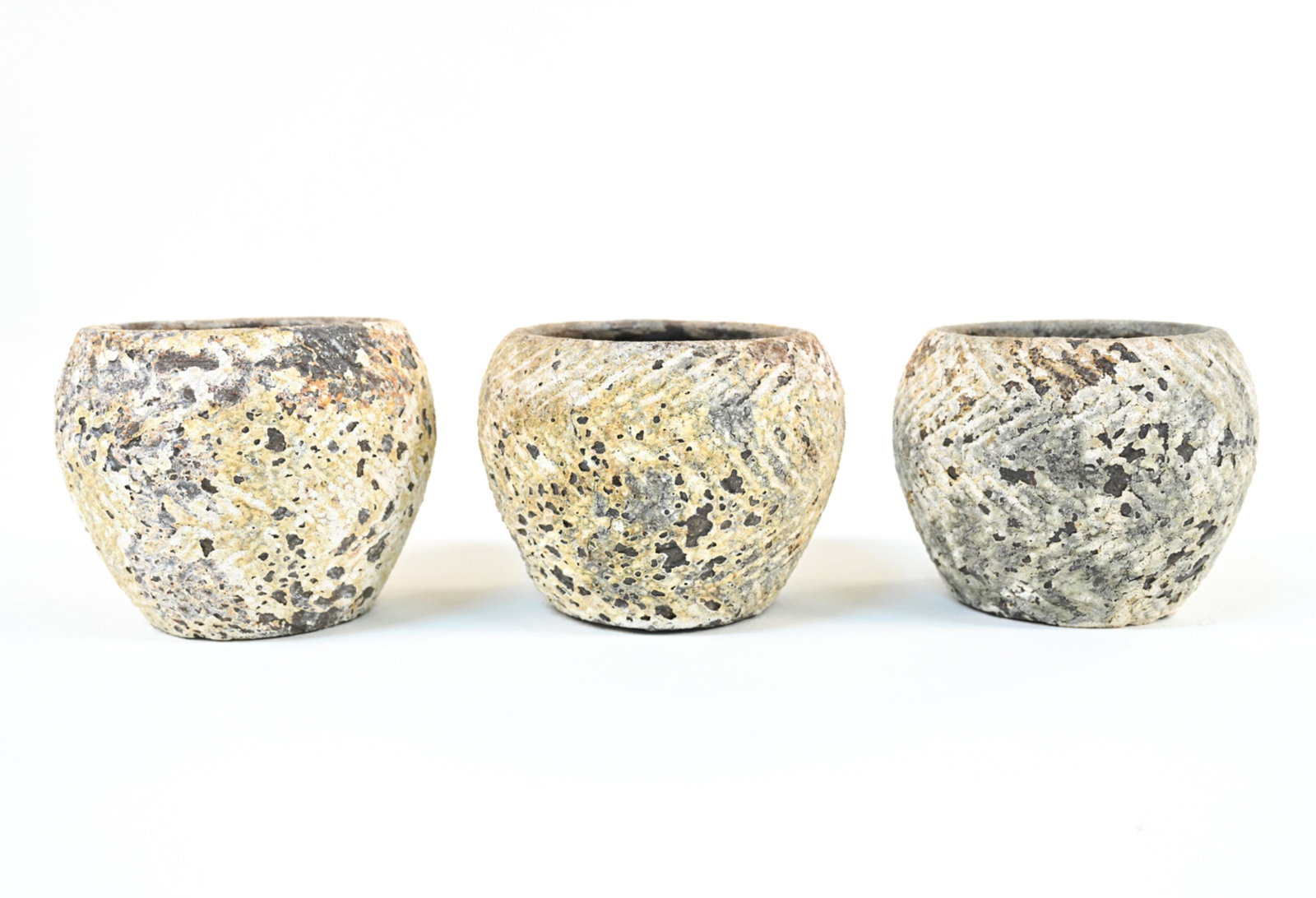 (3) EARTHENWARE PLANTERS: Dimensions: H 6.5" x Dia 8" Condition: Intentionally weathered finish, with some additional flaking and finish losses.