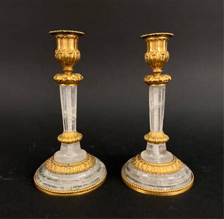 PAIR OF EMPIRE-STYLE ROCK CRYSTAL CANDLESTICKS: Rock crystal and ormolu. Dimensions: H 8" x Dia. 4" Condition: Some inclusions to rock crystal. One with chipping at inclusion to crystal on stem. Some light patina to ormolu. Wear consistent with