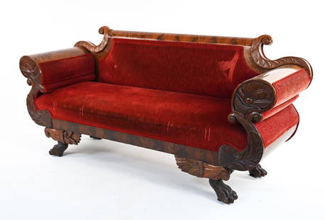 19TH C. CARVED PAW FOOT FLAME MAHOGANY SOFA: Fine semi-antique sofa in the Empire style, with ornately carved scrolled arms, winged paw feet., and sculpted chenille upholstery. Dimensions: H 36" x W 78" x D 24.5" x SH 18.5" Condition: Showing