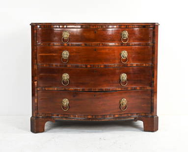 19TH C. JAMES WINTER & SONS SERPENTINE FRONT CHEST: Beautiful antique English chest of four graduated drawers - featuring quarter-sawn oak interiors and dovetailed joinery - with thick banded inlay, brass lion head ring pulls, and bracket feet.