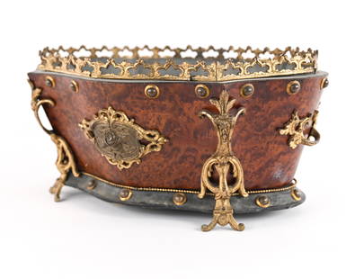 ANTIQUE BAROQUE-STYLE PLANTER: Wood planter with faux-birdseye finish, gilt bronze and brass mounts. Apparently unmarked. Dimensions: H 8" x W 17.5" x D 12.5" Condition: Gallery needs re-tacking along one side. Small break to botto