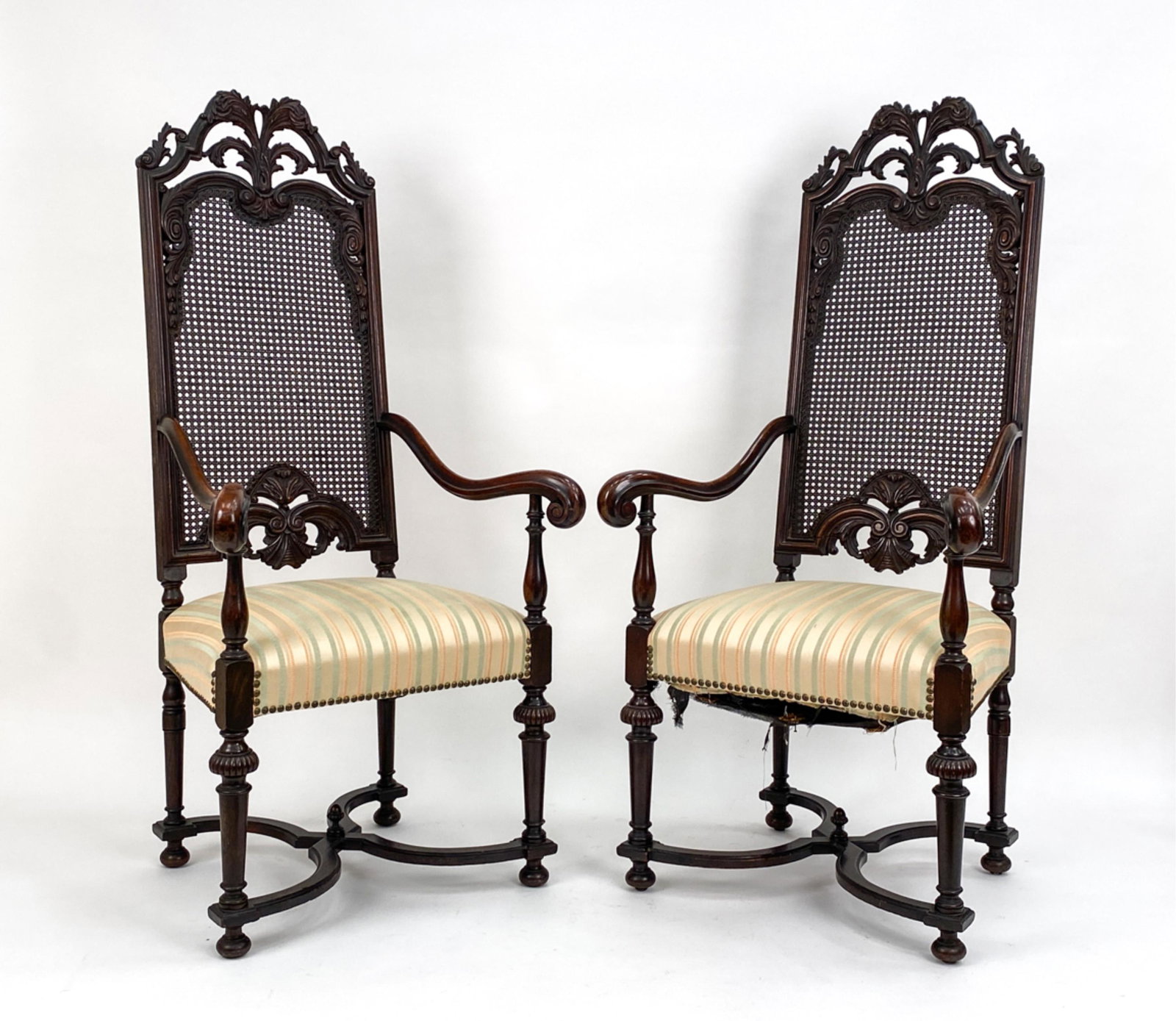 (2) HIGH-BACK CARVED MAPLE CHAIRS: Tall carved and cane backs, striped silk seats with nailhead trim. Including light blue fabric seat covers. Dimensions: H 55.5" x W 26" x D 22.5" x SH 19.5" Condition: Small chips and rubs to wood. Li
