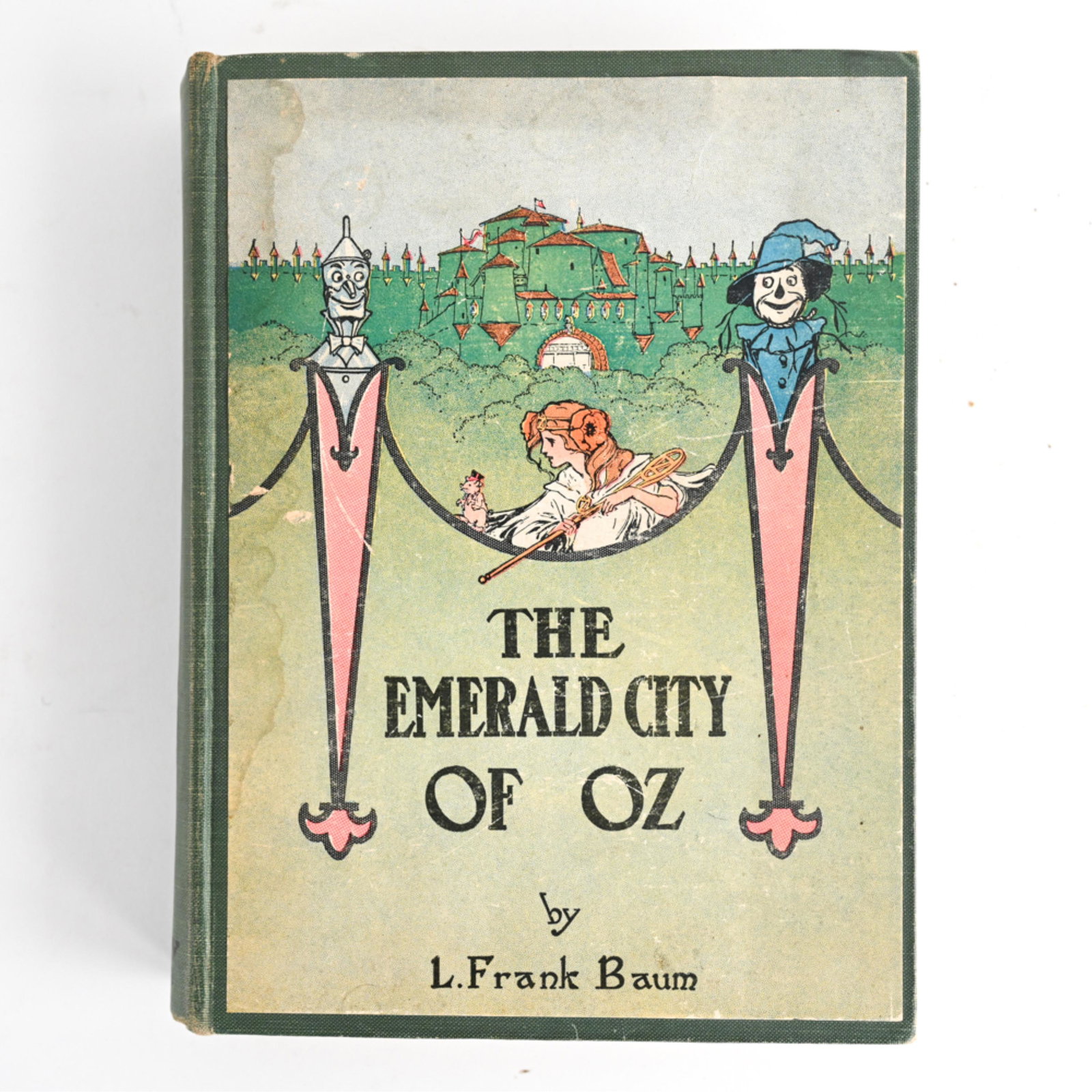 L. FRANK BAUM, THE EMERALD CITY OF OZ 1ST ED. 1910: Dimensions: H 9.25" x W 1.5" x D 7" Condition: Soiling, sun fading and age toning to cover, some bunting to corners, binding slightly loose; some age toning and handling wear to pages.