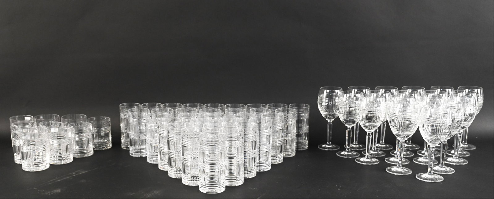 RALPH LAUREN GLEN PLAID CRYSTAL DRINKS SERVICE: Large grouping of barware from the Glen Plaid pattern by Ralph Lauren, with etched marks underneath. Includes: (15) wine glasses, (31) highball glasses, (8) Old Fashioned glasses, and (2) double Old F