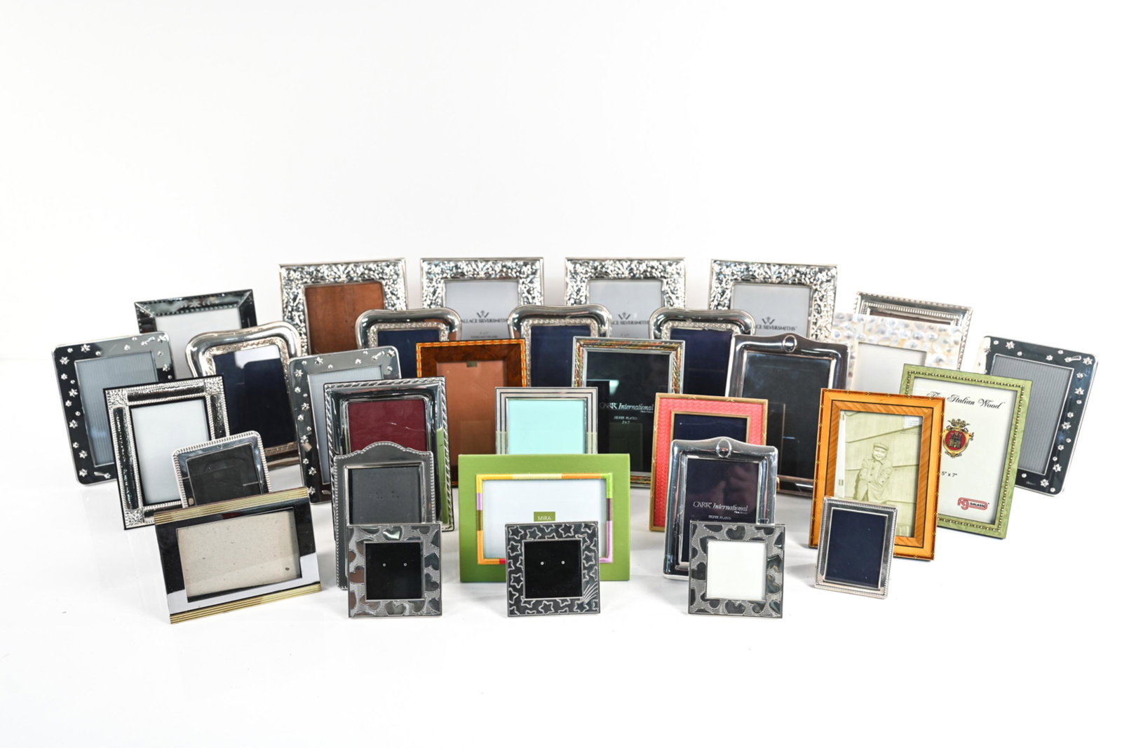 GROUPING PICTURE FRAMES INCL STERLING: Large grouping of smaller picture frames. Varied designs and sizes. Dimensions: (Largest): H 10" x W 8" x D .5" Condition: Wear is consistent with age and use.