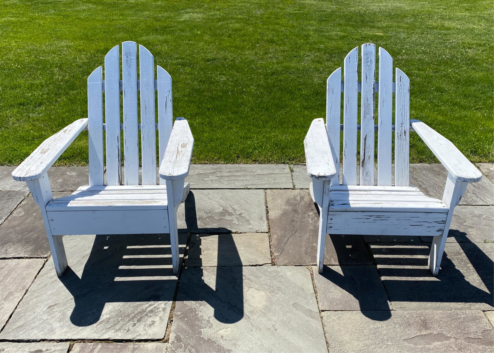 PAIR OF OUTDOOR ADIRONDACK CHAIRS: No apparent labels. Dimensions: H 36.5" x W 38" x D 29" x SH 15.5" Condition: Wear consistent with outdoor exposure including paint losses. Weathering to surfaces.