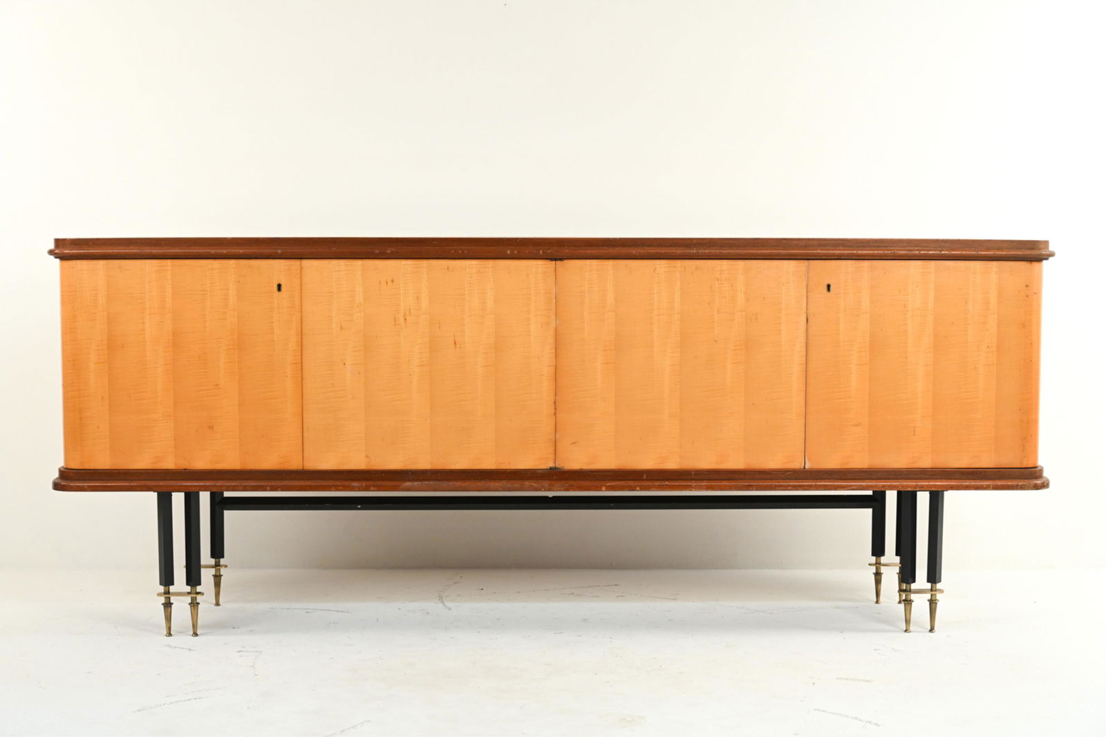 ATTR. BATISTIN SPADE FRENCH ART DECO SIDEBOARD: Beautiful period Art Deco sideboard or buffet with satin birch wood fronts, on highly decorative iron and brass legs. Attributed to Batistin Spade, with NF quality label inside door. Dimensions: H 36.