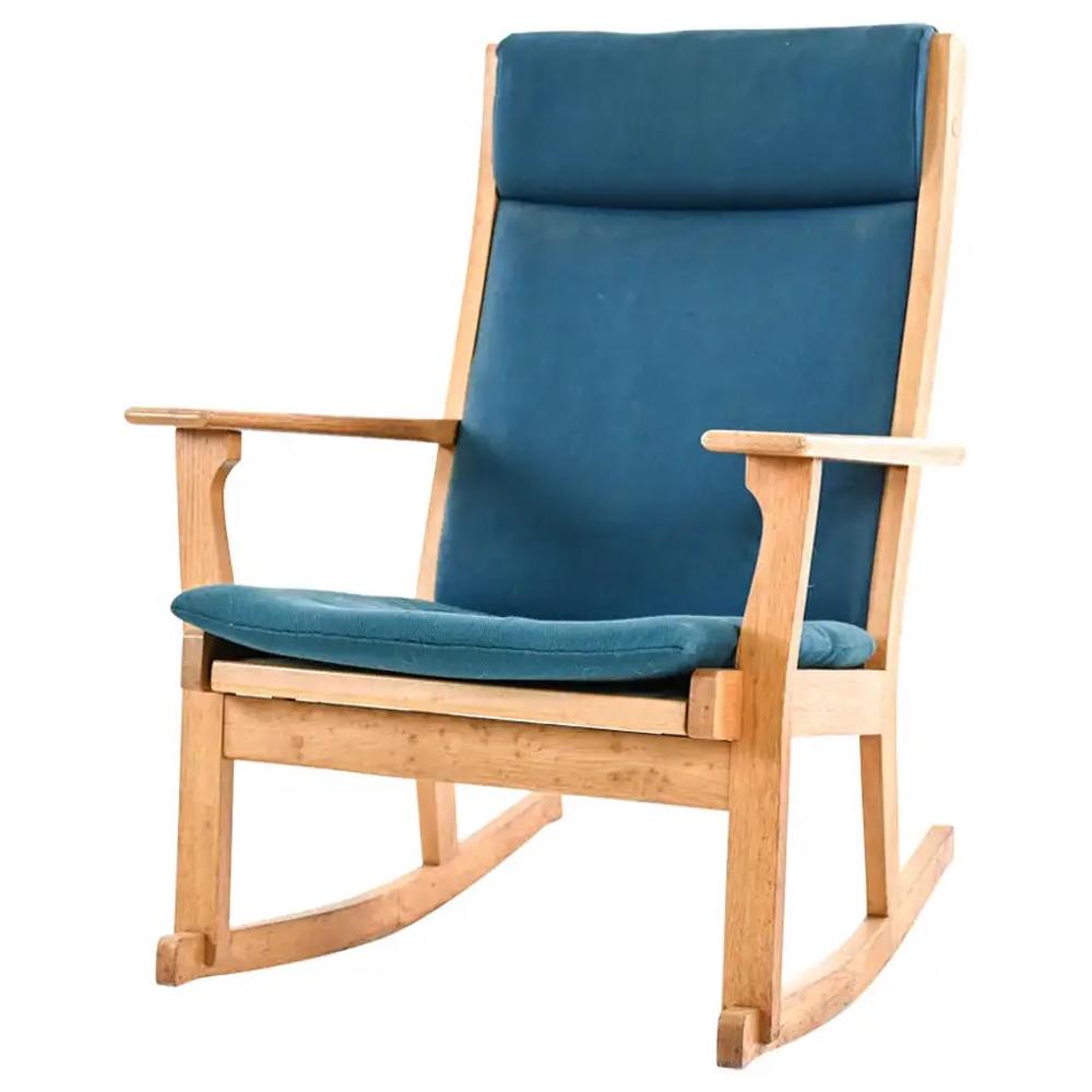 HANS WEGNER DANISH MID-CENTURY ROCKING CHAIR: A mid-20th century Scandinavian modern rocking chair designed by Hans Wegner. Dimensions: H 40.5" x W 29.5" x D 33" x SH 21.5" Condition: Wear consistent with age and use. Minor fading. Some marks to