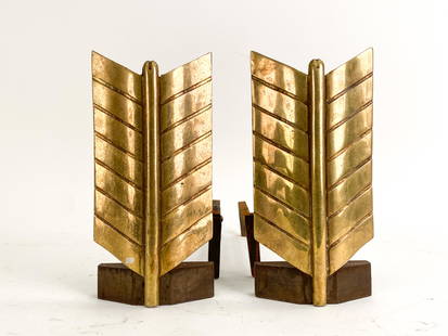 DONALD DESKEY BRASS & IRON ARROW ANDIRONS: Brass fireplace andirons arrow motif. Impressed mark Bennett on one, Puritan on the other. Dimensions: H 13.25" x W 6.5" x D 18.5" Condition: Surface wear, scratches and some rust consistent with age