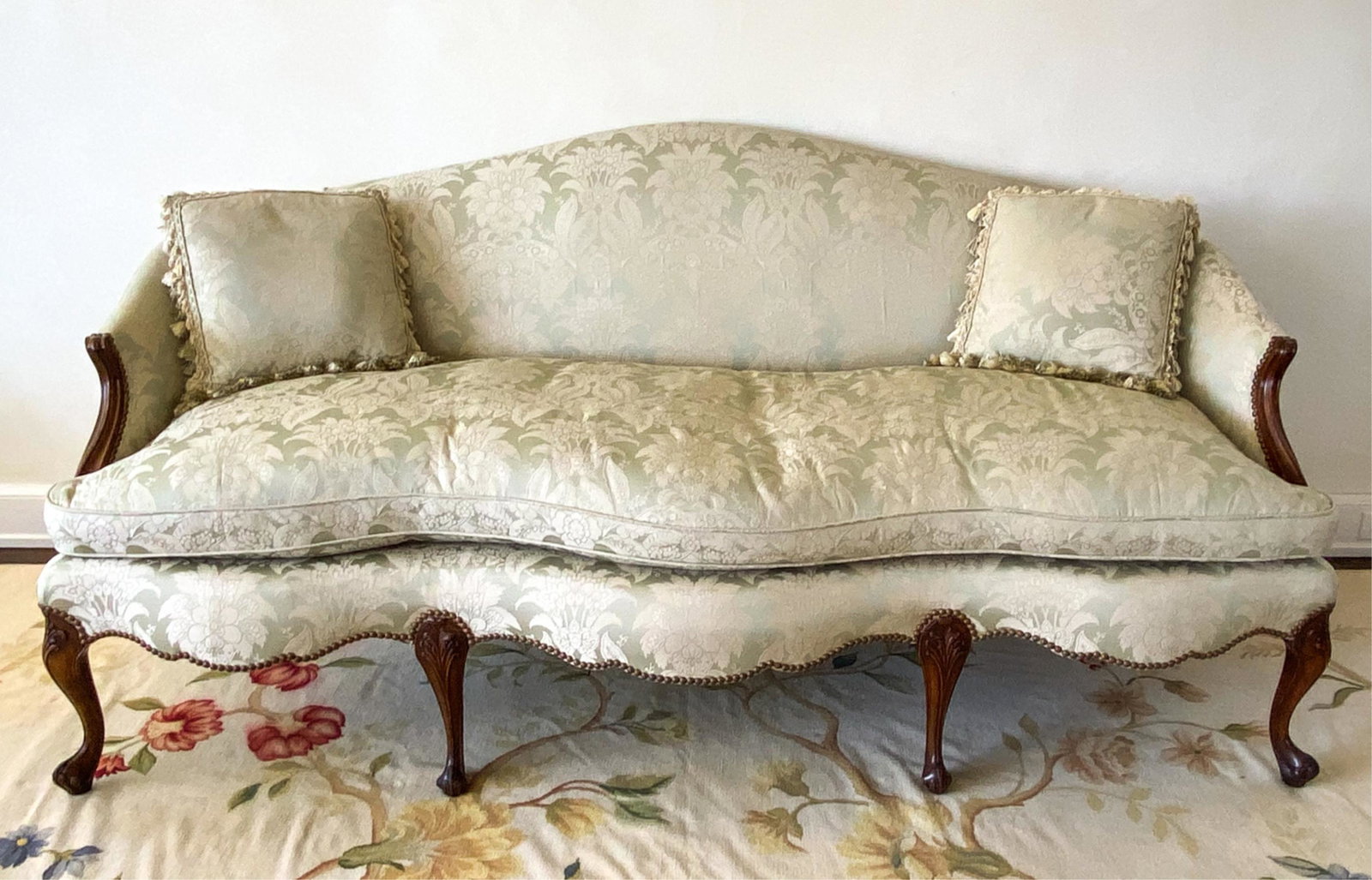 PERIOD GEORGE II SOFA: Damask upholstery. Shaped back and front, with nailhead trim. Carved legs and sides. Dimensions: H 38" x W 80" x D 36" x SH 22" Condition: Few small spots of soiling to upholstery. Wear consistent wit