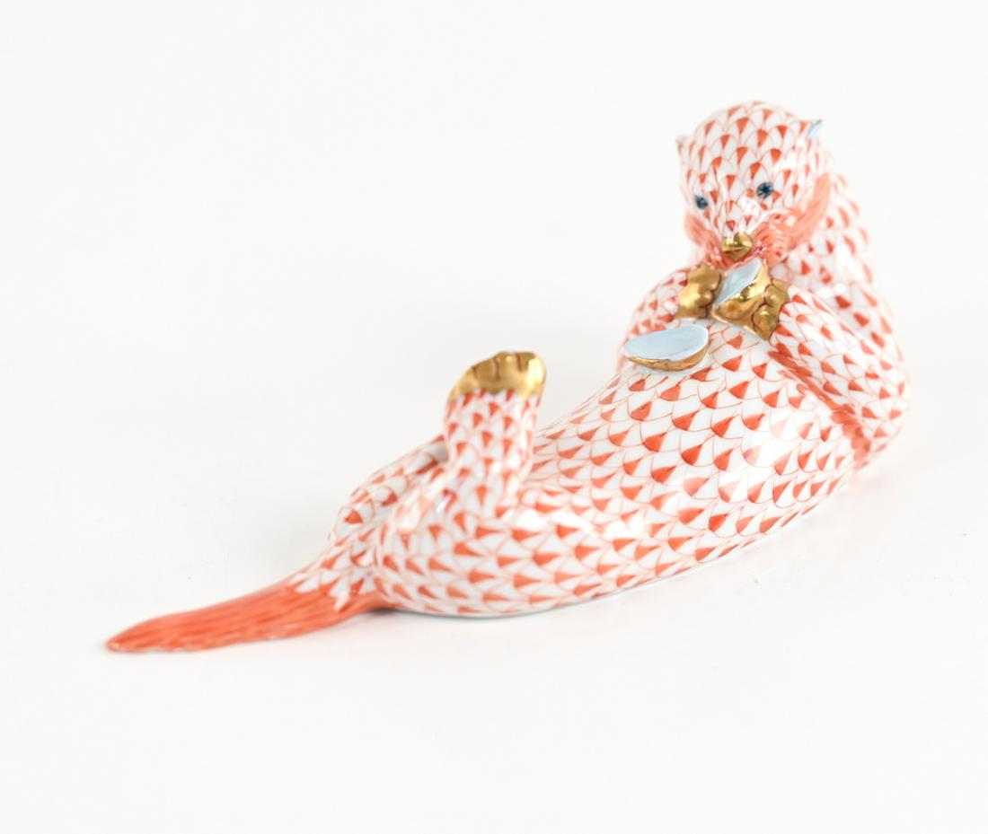 HEREND PORCELAIN SEA OTTER WITH CLAM: Model No. 15364, marked underneath. Dimensions: H 2.75" x L 7.75" x W 2.5' Condition: One tiny flea bite to otter's back left foot; otherwise showing very few signs of wear.