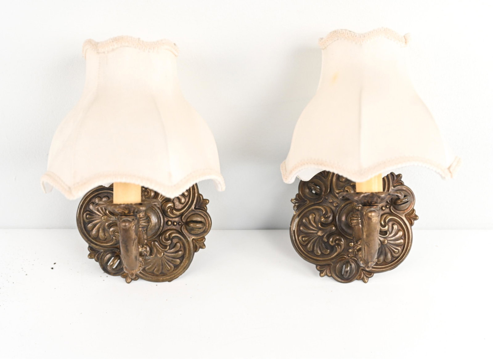 PAIR OF EARLY 20TH C. SCONCES: Apparently unmarked. Dimensions: (Without shades) H 9" x W 5.5" x D 6" Condition: Wiring not tested. Metal with surface tarnish and aged patina, spots of soiling to shades, age toning to socket covers