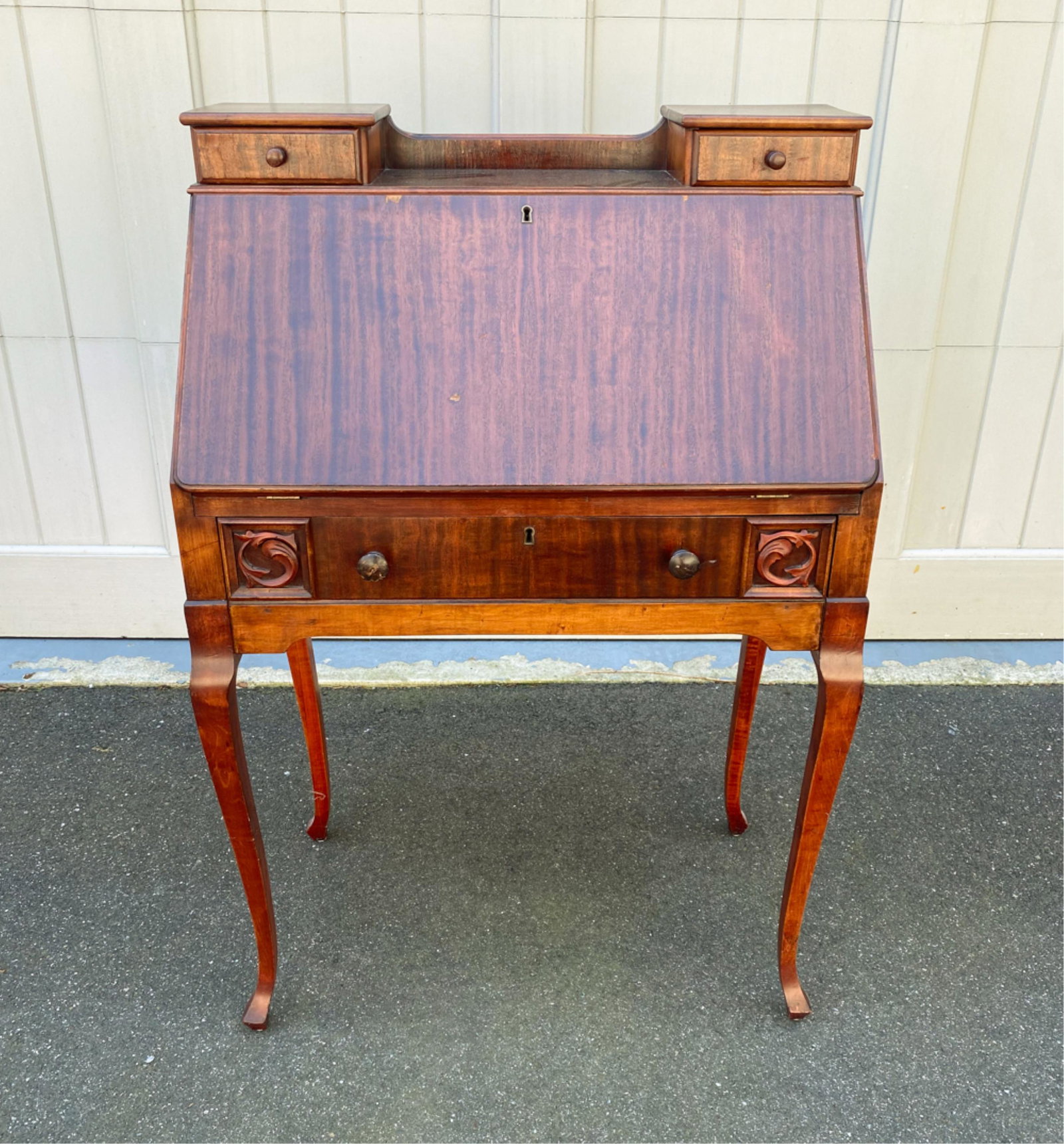 CRON-KILLS SECRETARY DESK: With manufacturer's mark verso. Slanted drop front, fitted interior. Dimensions: H 41.25" x W 28" x D 15.5" Condition: Losses to veneer, no key, scratches to writing surface. Splits to wood.