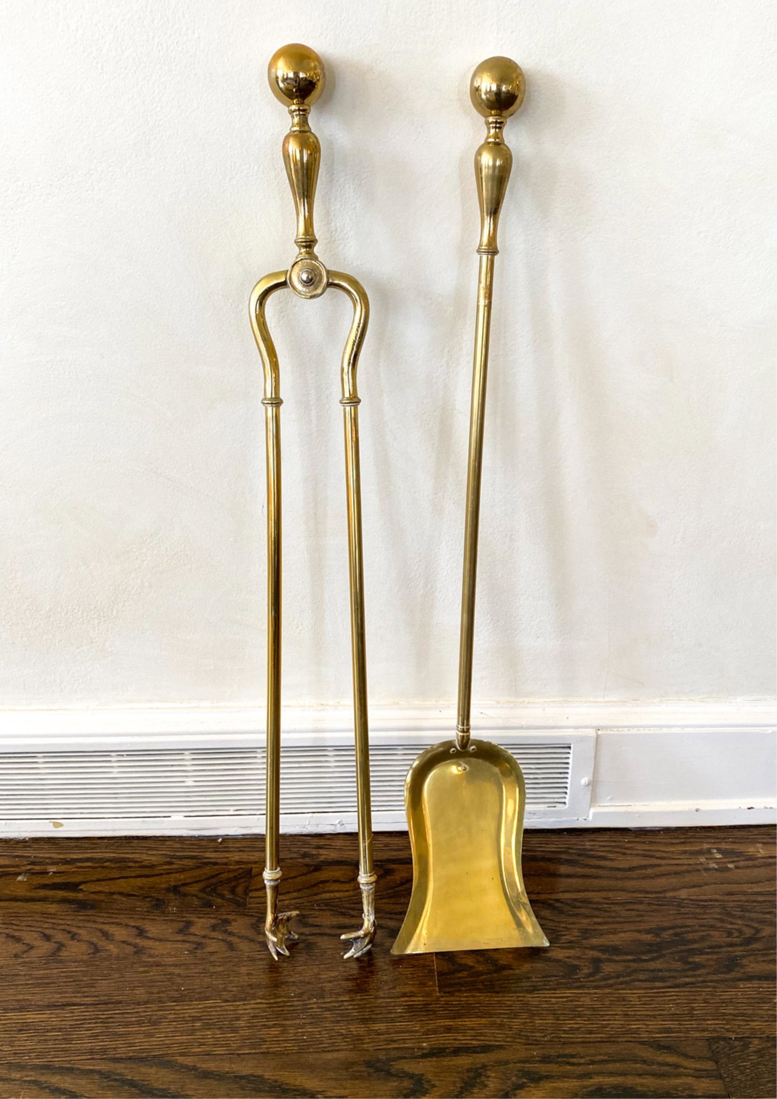 BRASS FIREPLACE TOOLS: Shovel and tongs. Dimensions: (Tongs) H 32" x W 4" Condition: Wear consistent with use.