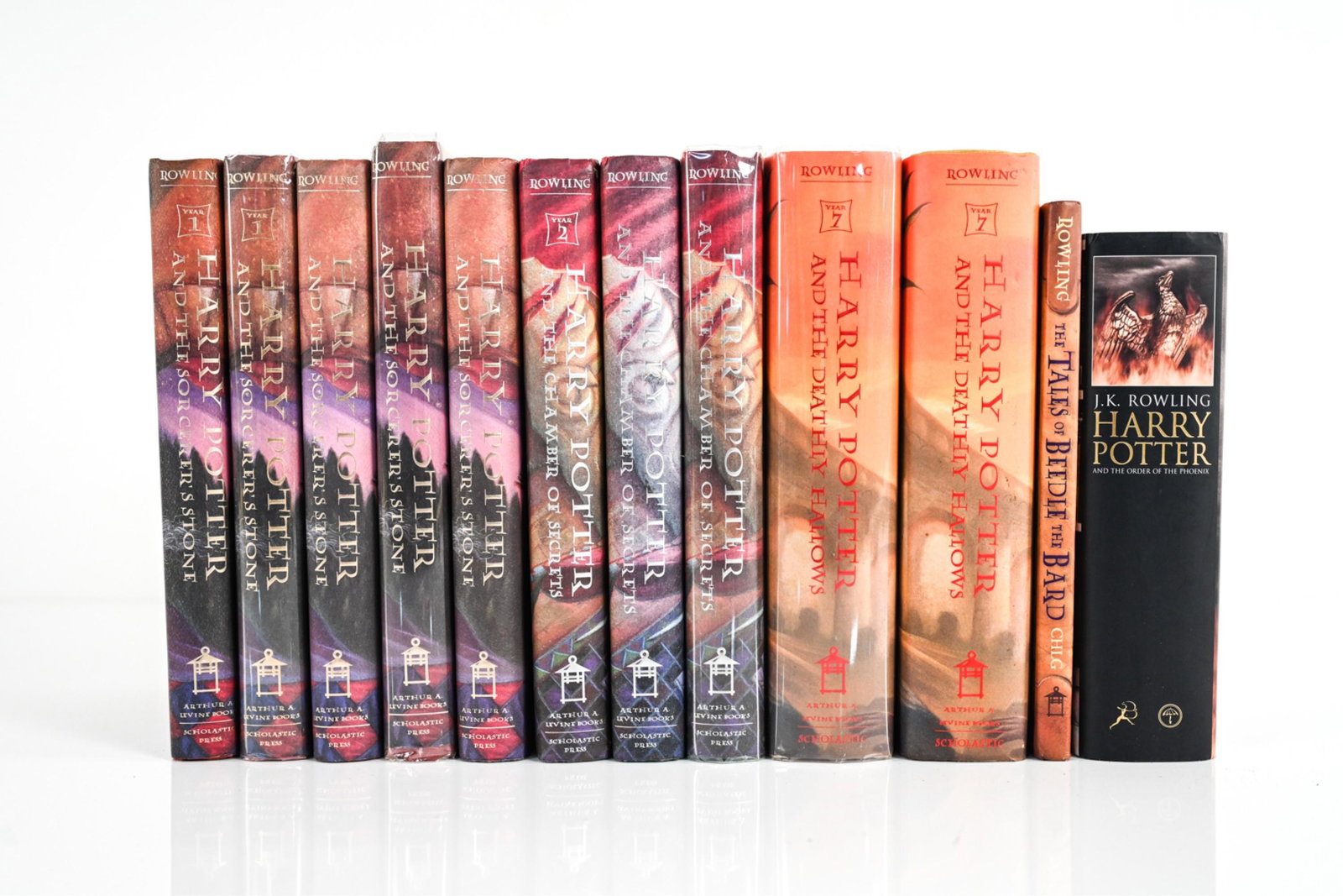 (12) HARRY POTTER 1ST AMERICAN & CANADIAN EDITIONS: Including: (5) The Sorcerer's Stone, (3) The Chamber of Secrets, (1) 1st Canadian Ed. The Order of the Phoenix; (2) The Deathly Hallows, and (1) The Tales of Beedle the Bard. Dimensions: (Largest, Dea