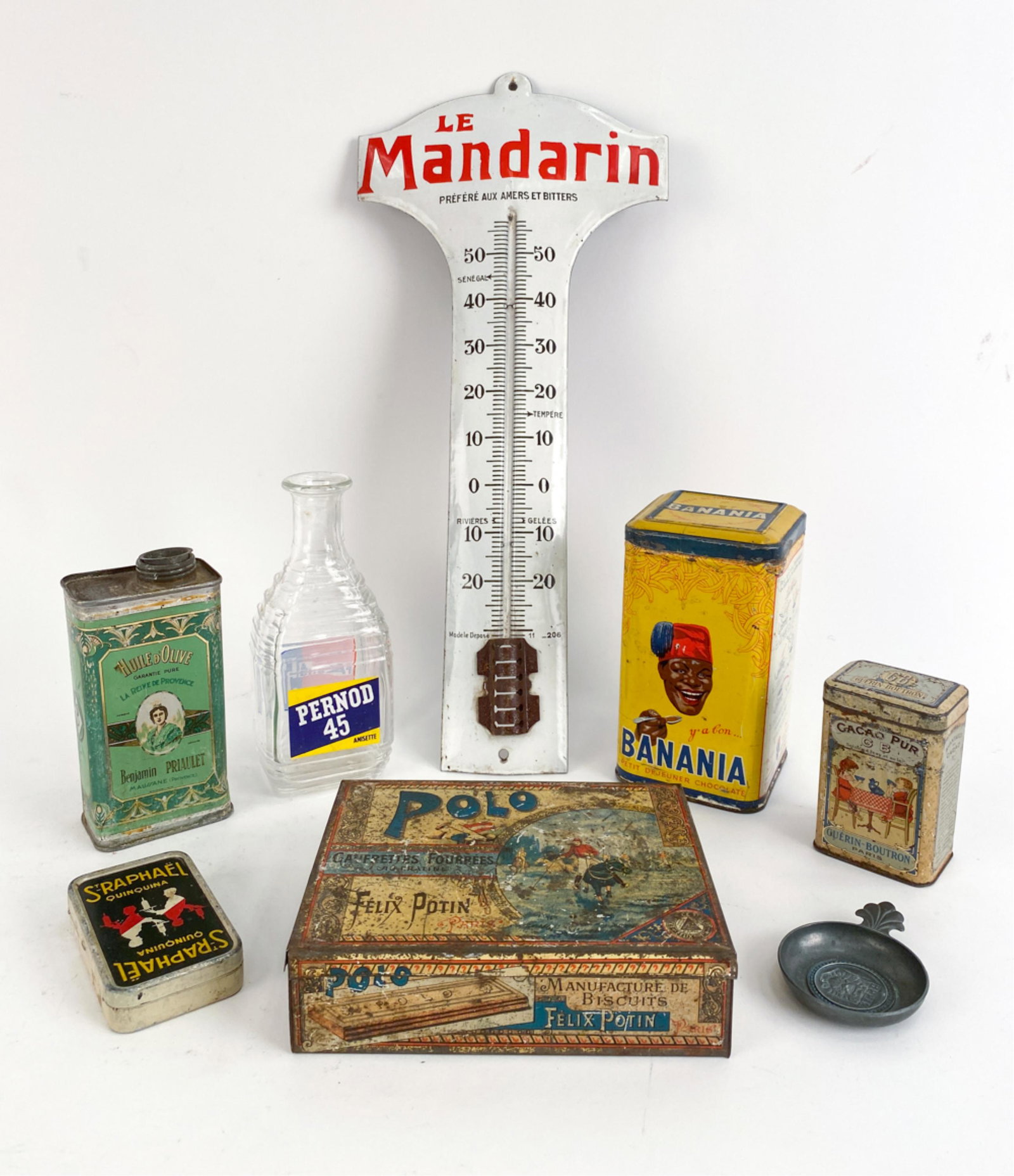 RARE FRENCH ADVERTISING GROUPING: Raphael Quionia, an aperitif, advertising cards tole box, olive oil tin for Olive oil Maussane, metal wine taster imprinted with Byrrh, Tole box of 'Polo' cookies, Banania, a type of oatmeal mixture, 