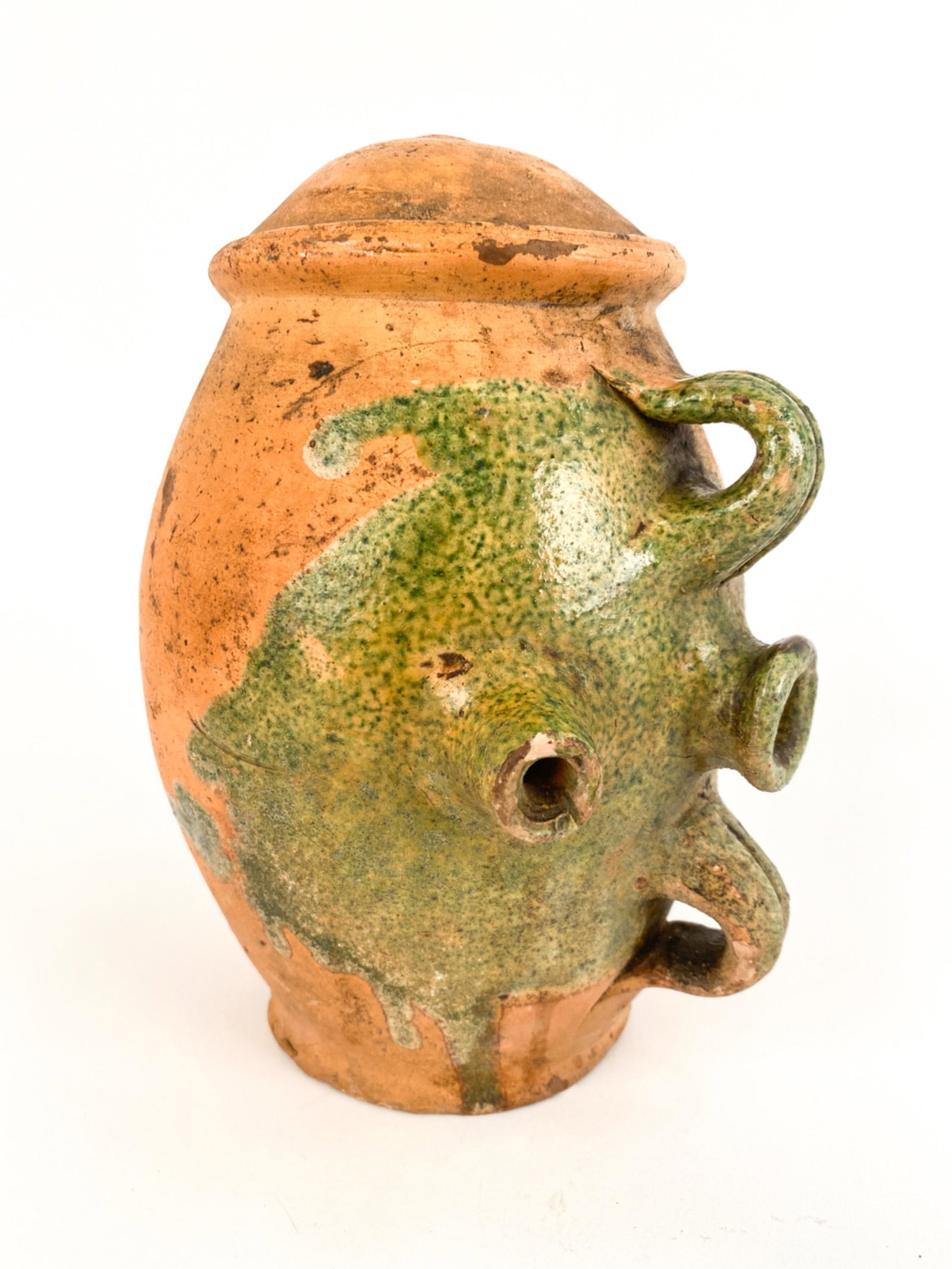 18TH C. FRENCH ANTIQUE VINEGAR POTTERY: Stonge design. Green glaze in bib form around neck. Dimensions: H 9" x W 5.75" x D 5.75" Condition: Some chips, surface marks and wear. Wear consistent with age and use.