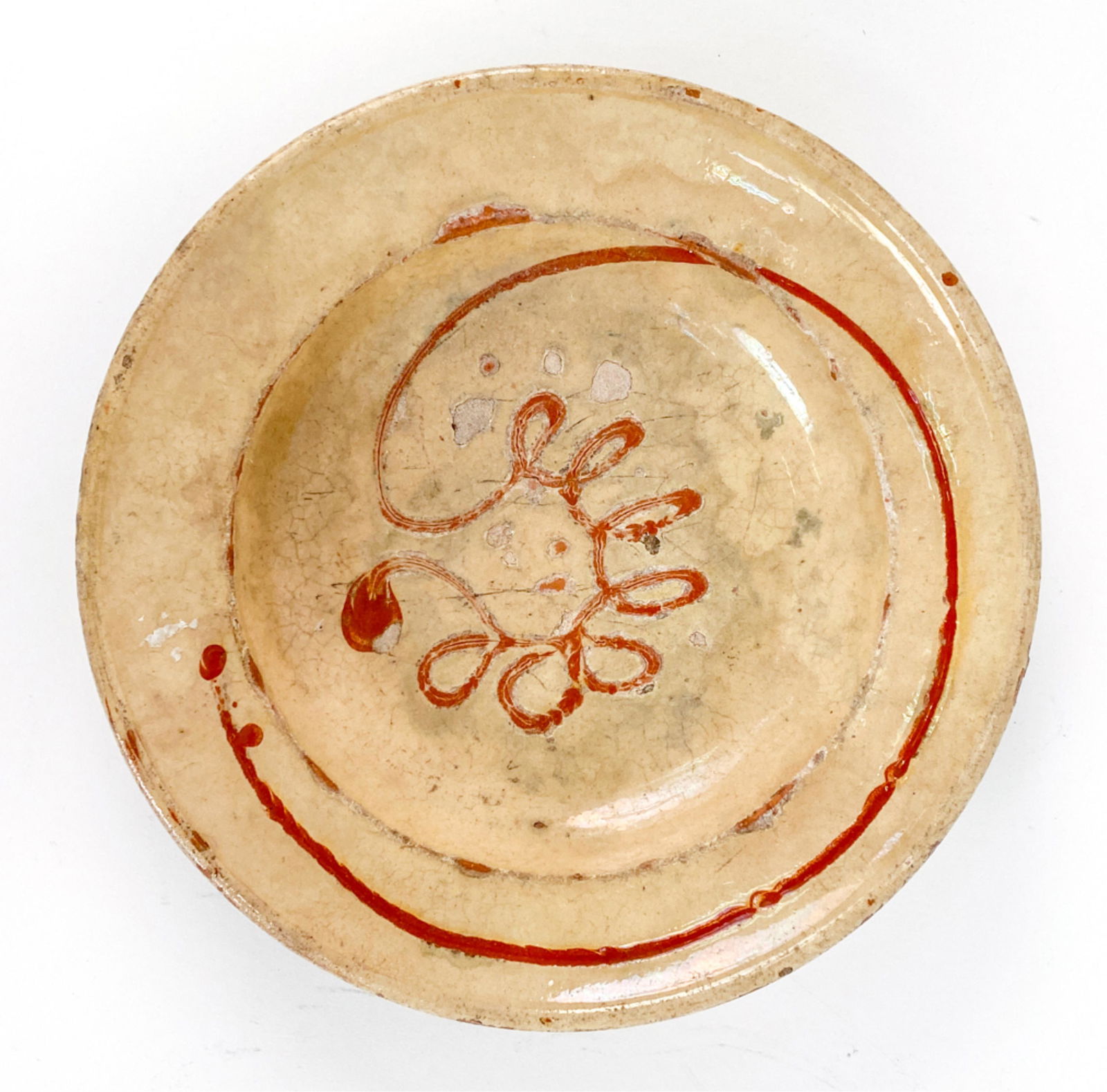 FRENCH ANTIQUE EARTHENWARE PROVENCAL PLATE: 18th c. serving plate with design and shape of poterie atelier of Biot. Dimensions: H 2" x Dia. 10.5" Condition: Glaze chips and losses, crazing, scratches, and wear.
