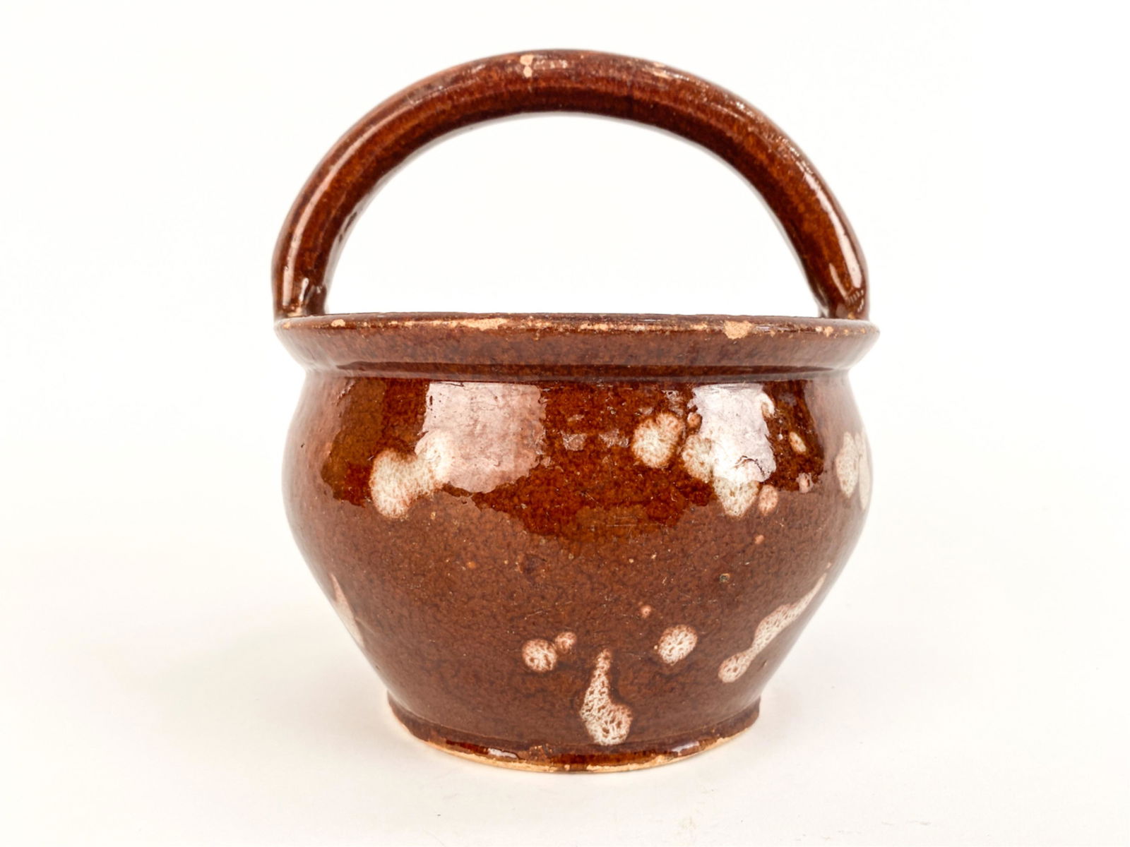 FRENCH ANTIQUE "PORT DINER" POTTERY VESSEL: A ubiquitous vessel in caramel-colored glaze with taches, for transporting food outside the home. Dimensions: H 7.75" x Dia. 7" Condition: Crazing, small chips and losses to glaze. Wear consistent wit