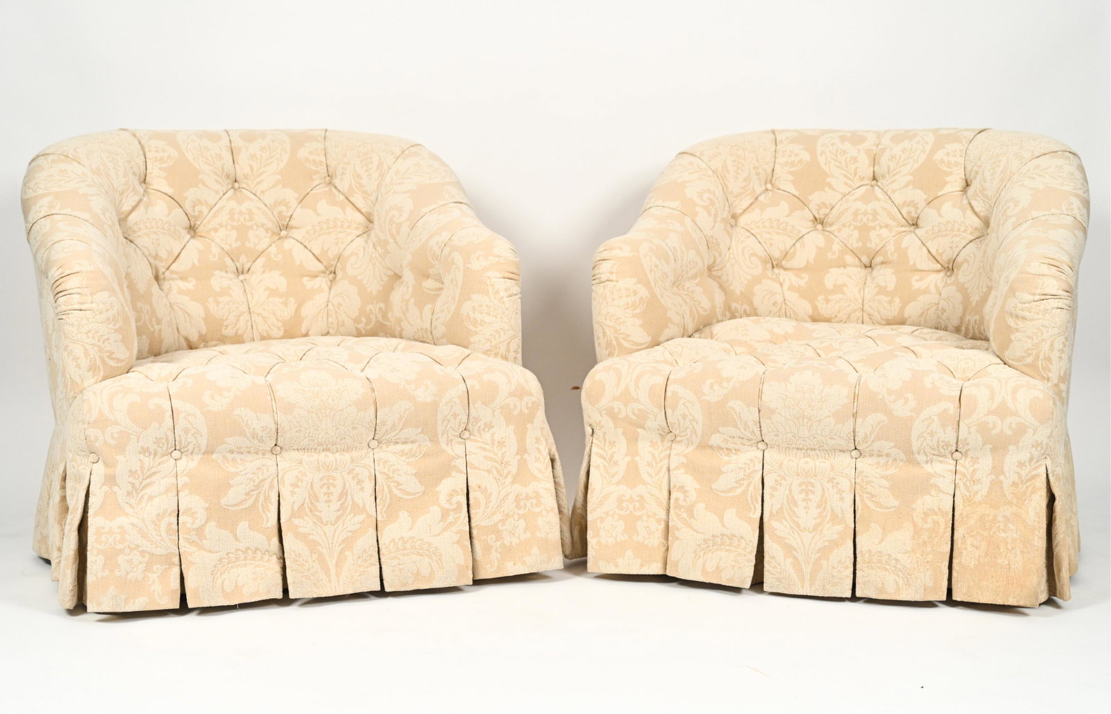 PAIR OF BUTTON TUFTED CLUB CHAIRS: Button tufted club chairs with rolled arms and damask pattern upholstery. Dimensions: H 30" x W 34" x D 38" SH 15" Condition: A few spots of soiling to skirt.